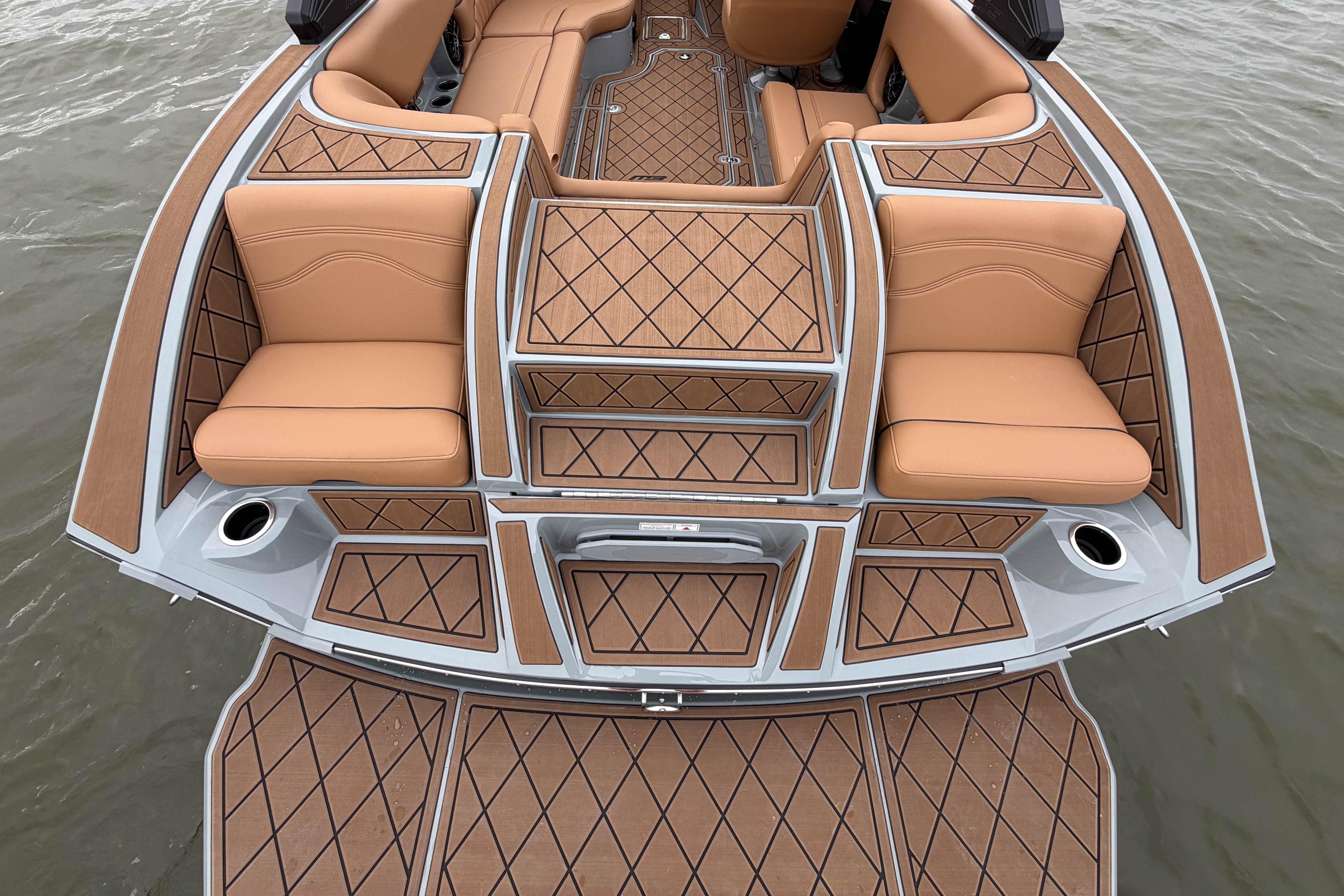 2026 MB B52 21 Alpha boat interior with tan seating and diamond-patterned flooring.