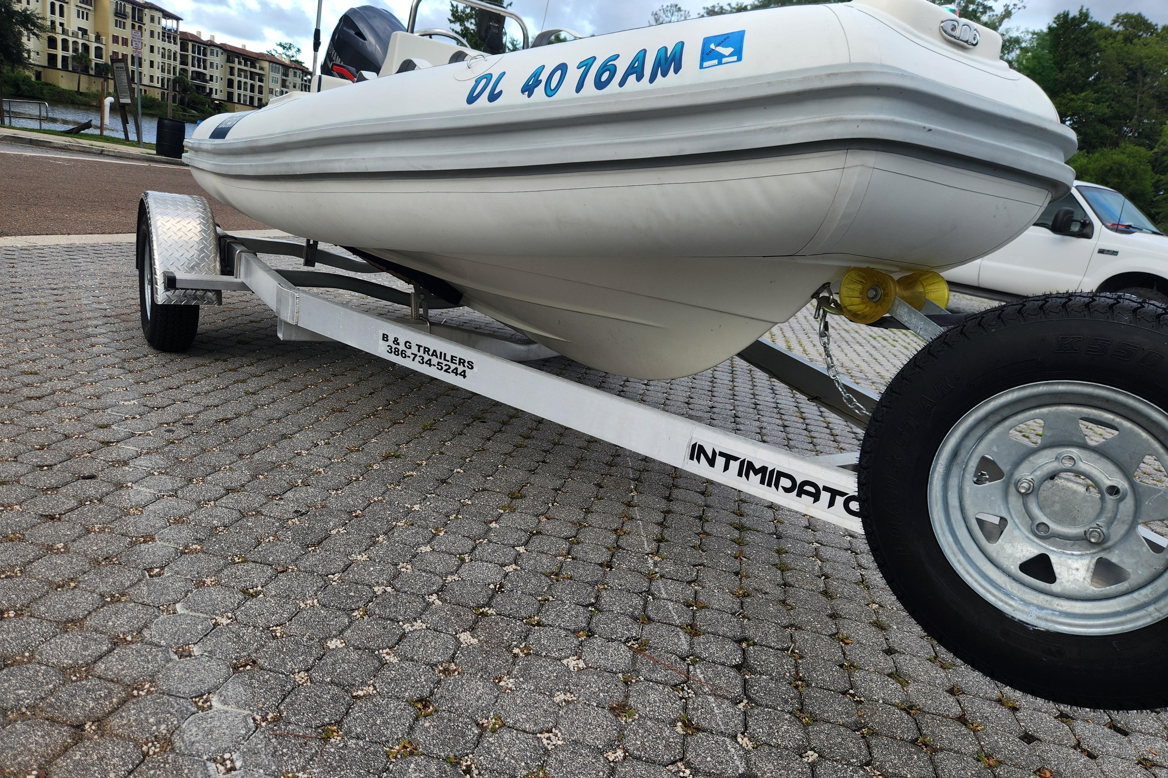 2019 Novurania DL 400 boat on trailer, parked on paved surface.