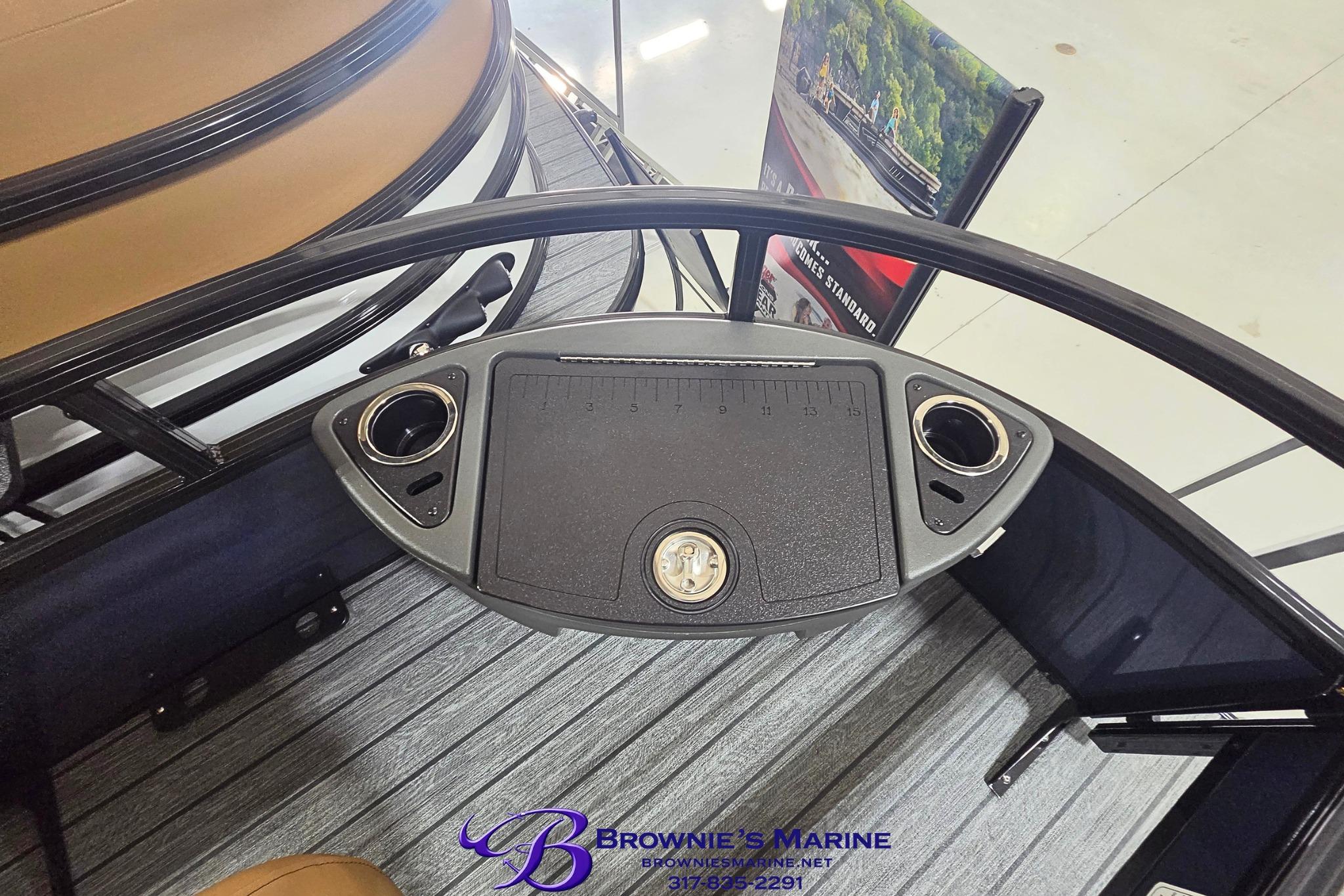 Control panel of 2026 Ranger 220F boat with cup holders and measurement markings.