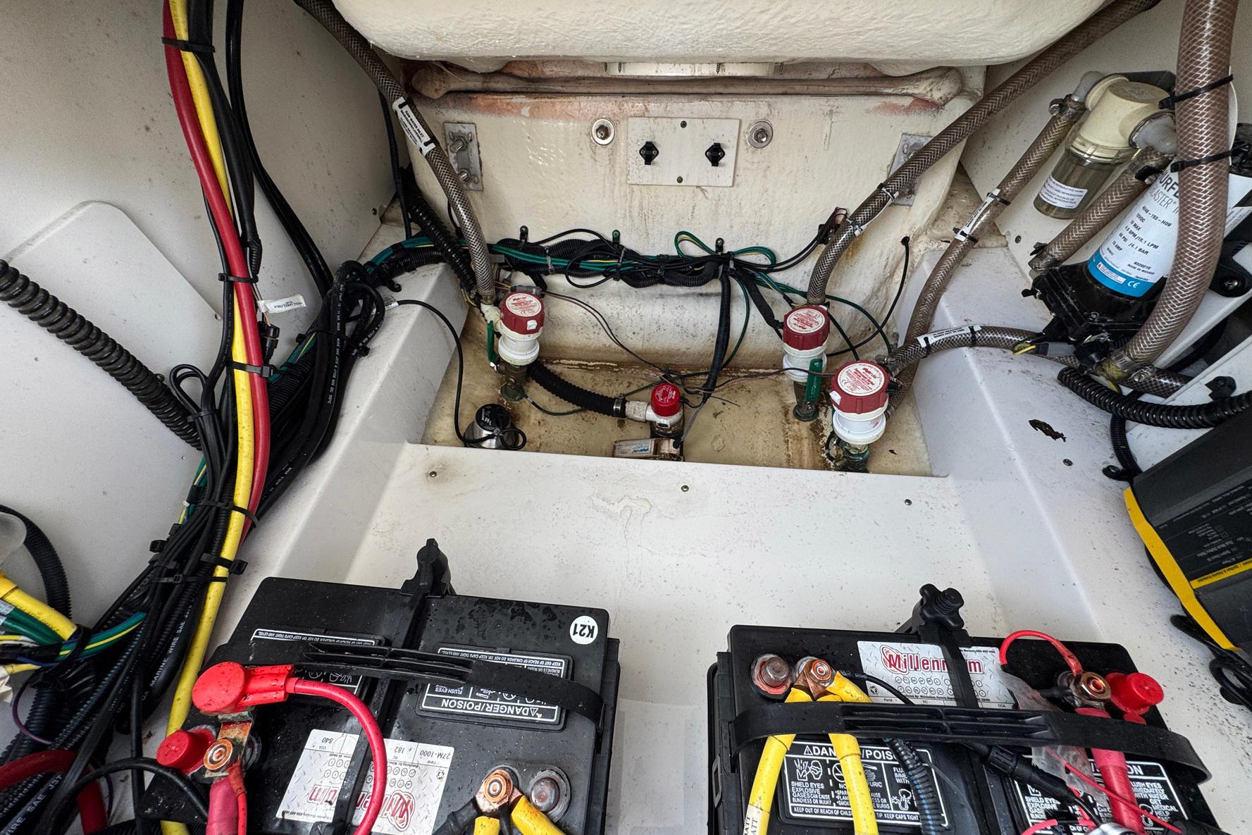 2021 Robalo 246 Cayman boat interior showing wiring and battery setup.