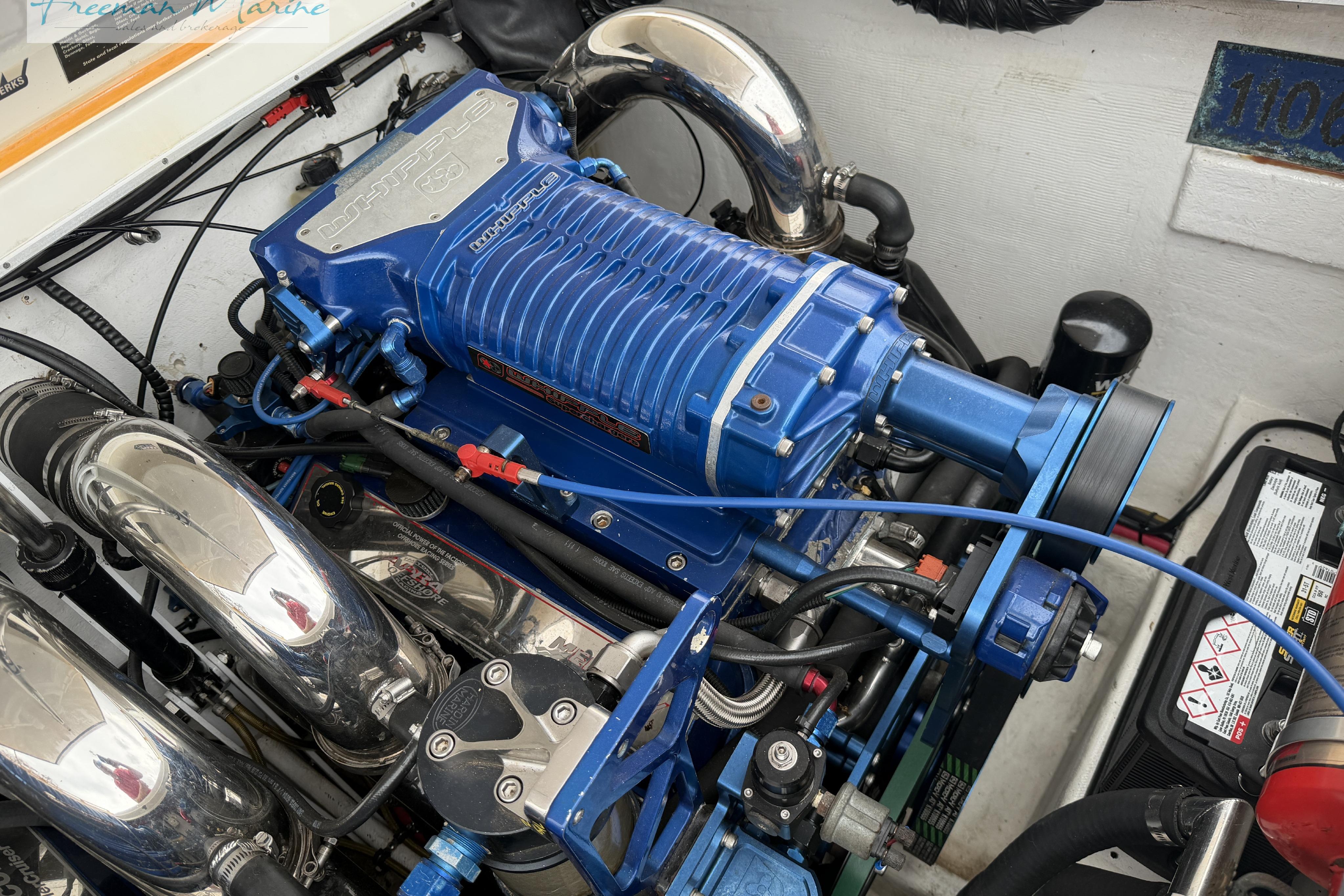 Engine of a 2000 Cigarette 30' Mystique boat with blue Whipple supercharger.