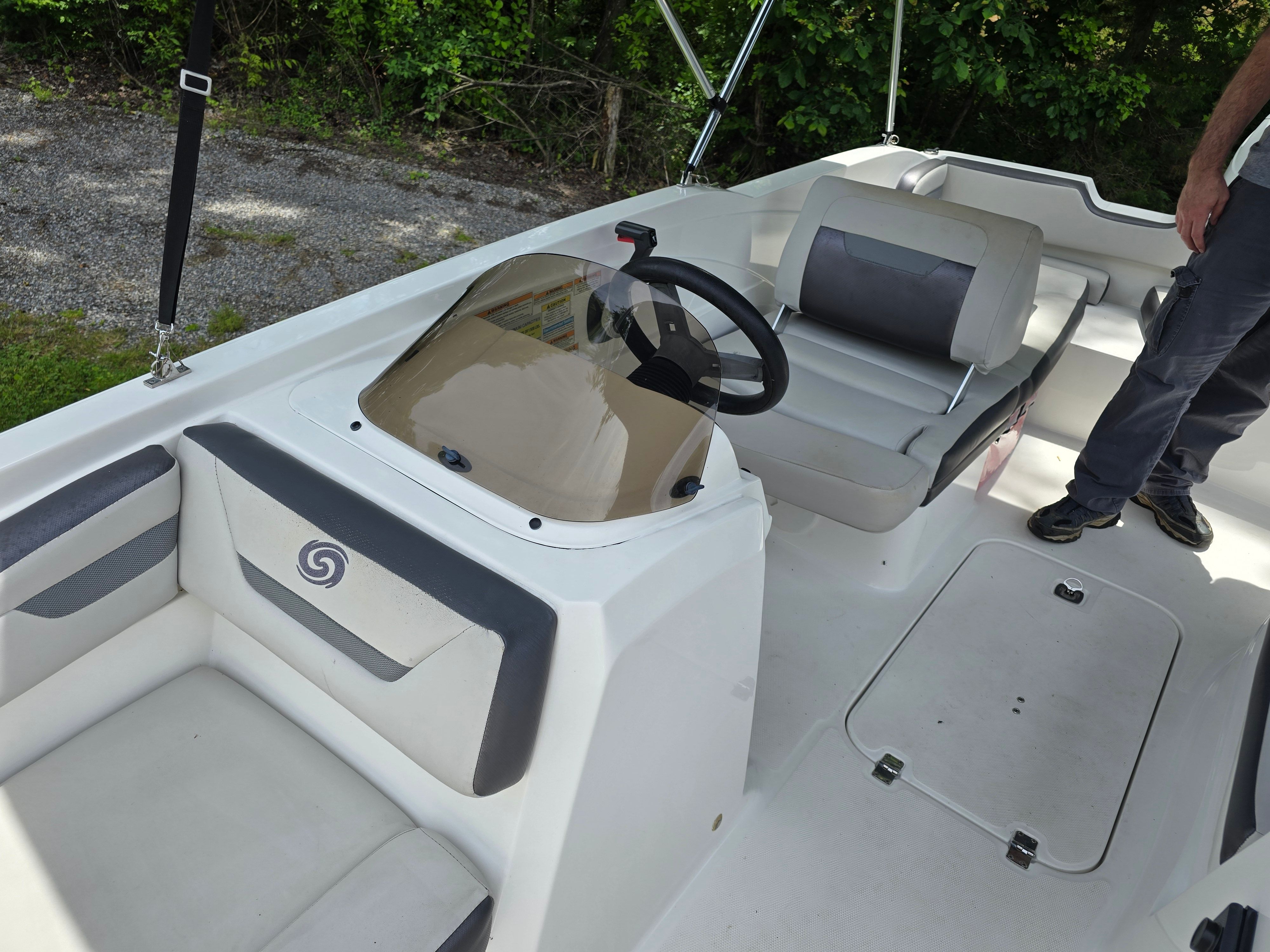 Interior of a 2021 Hurricane 205SS boat with steering wheel and seats.