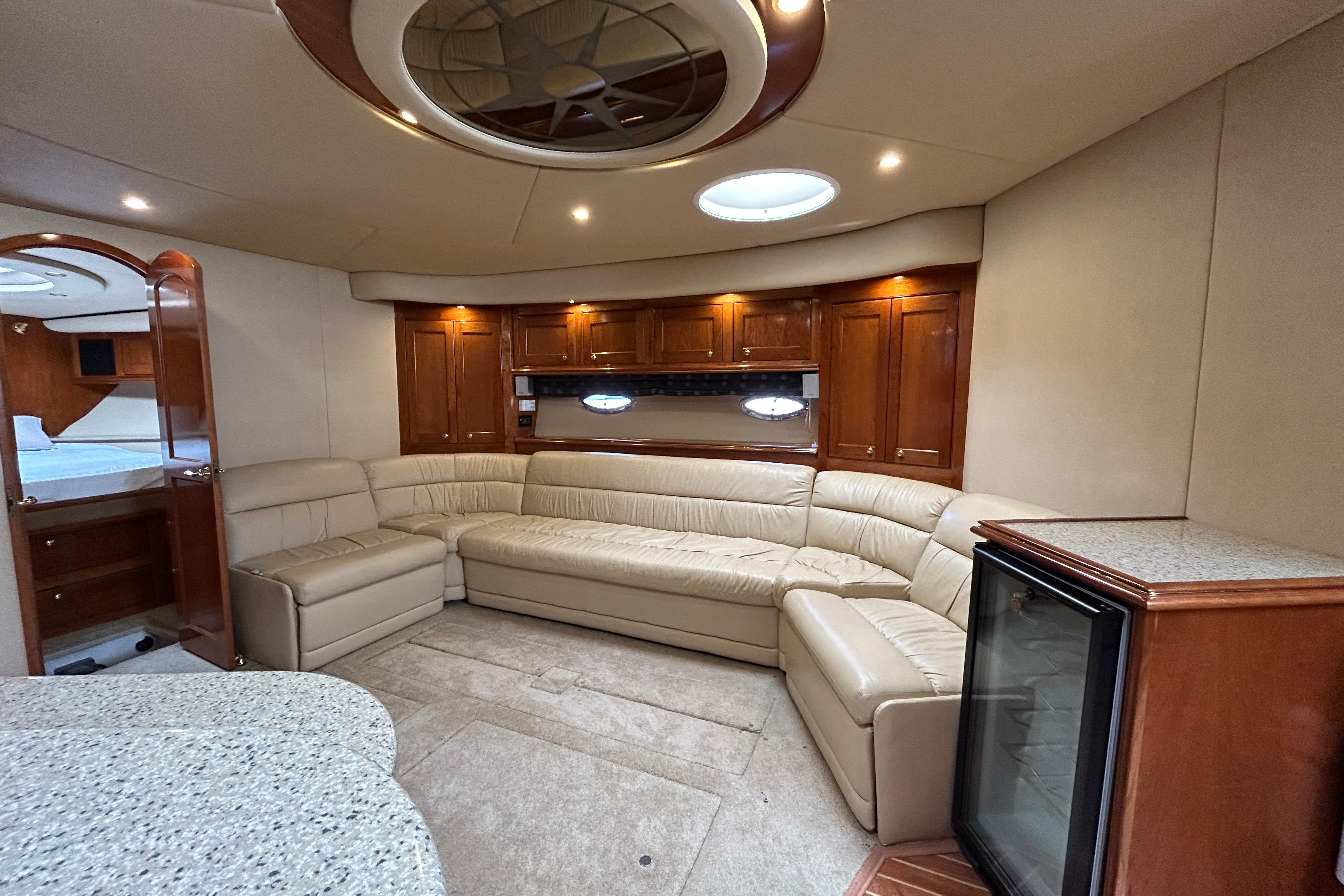 Luxurious interior of 2003 Cruisers Yachts 540 Express with leather seating and wood cabinetry.