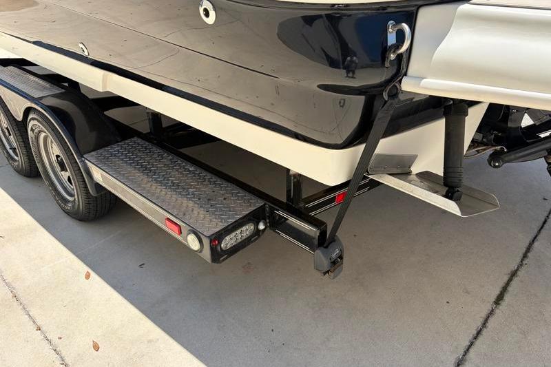 2007 Sea Ray 240 Sundeck boat on trailer, rear view showing hull and step.