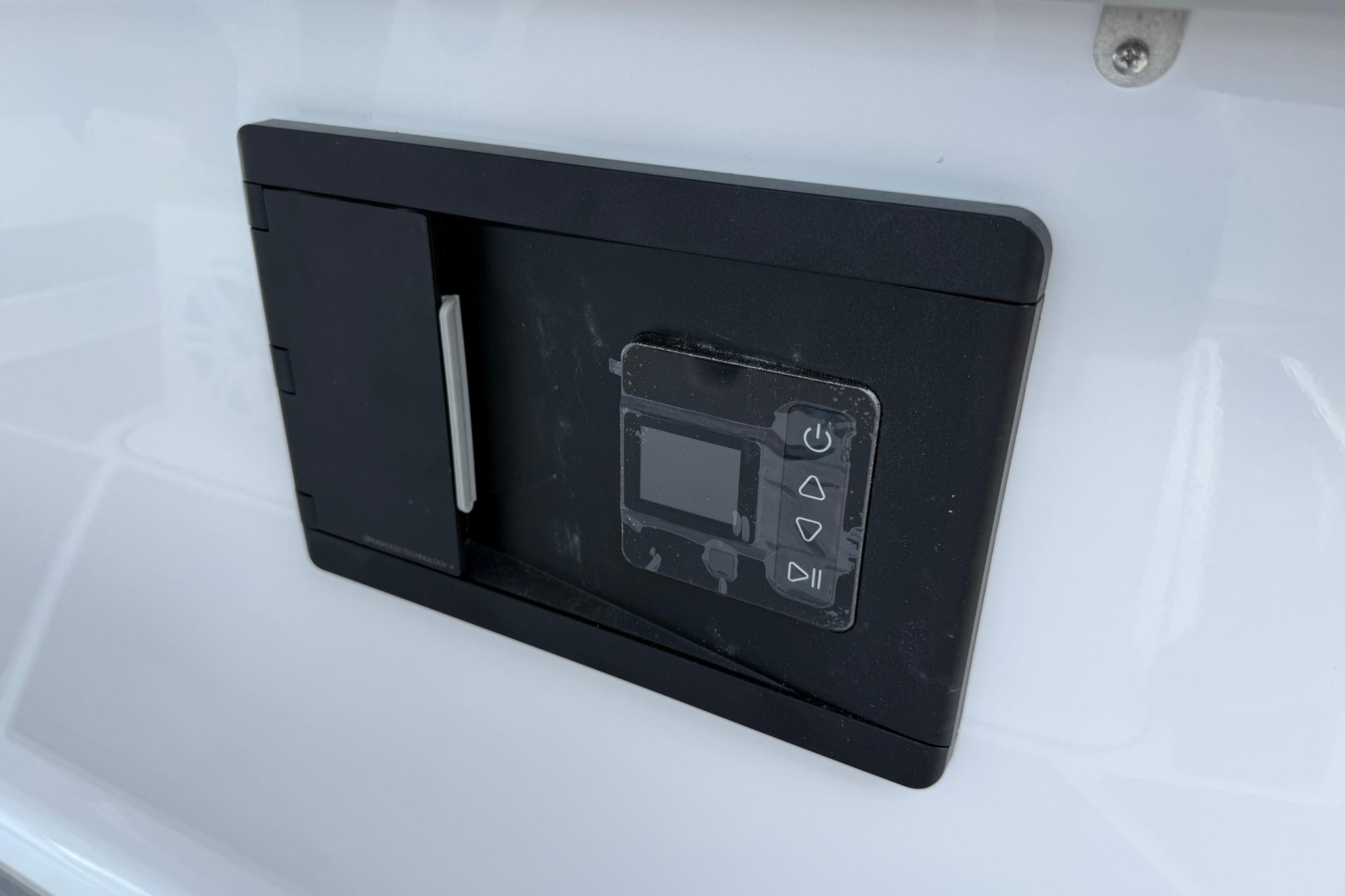 Control panel on a 2027 Monterey Elite 30 OB boat, featuring a sleek black design.