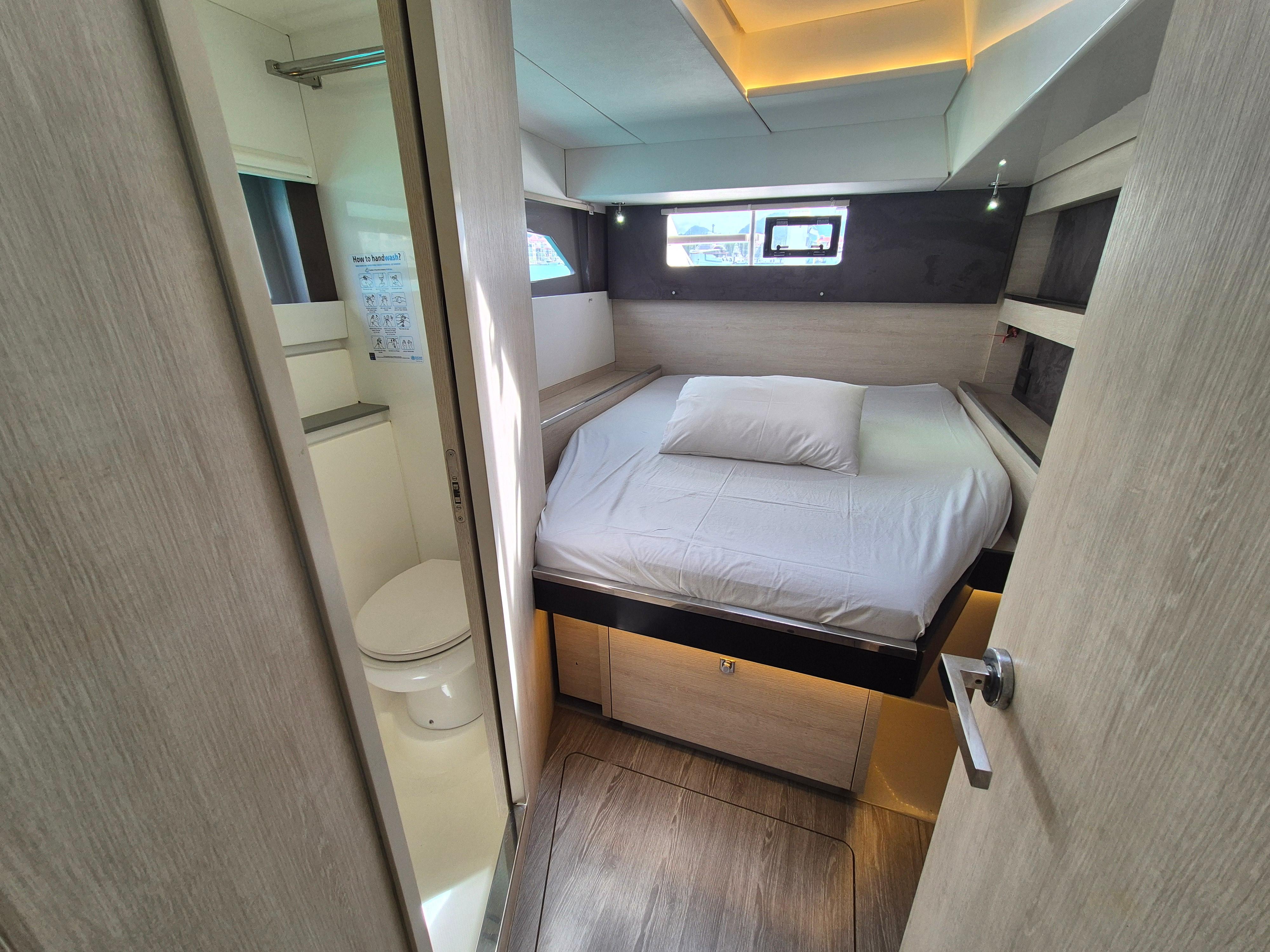 Modern bedroom and bathroom interior on a 2020 Leopard 50 yacht.