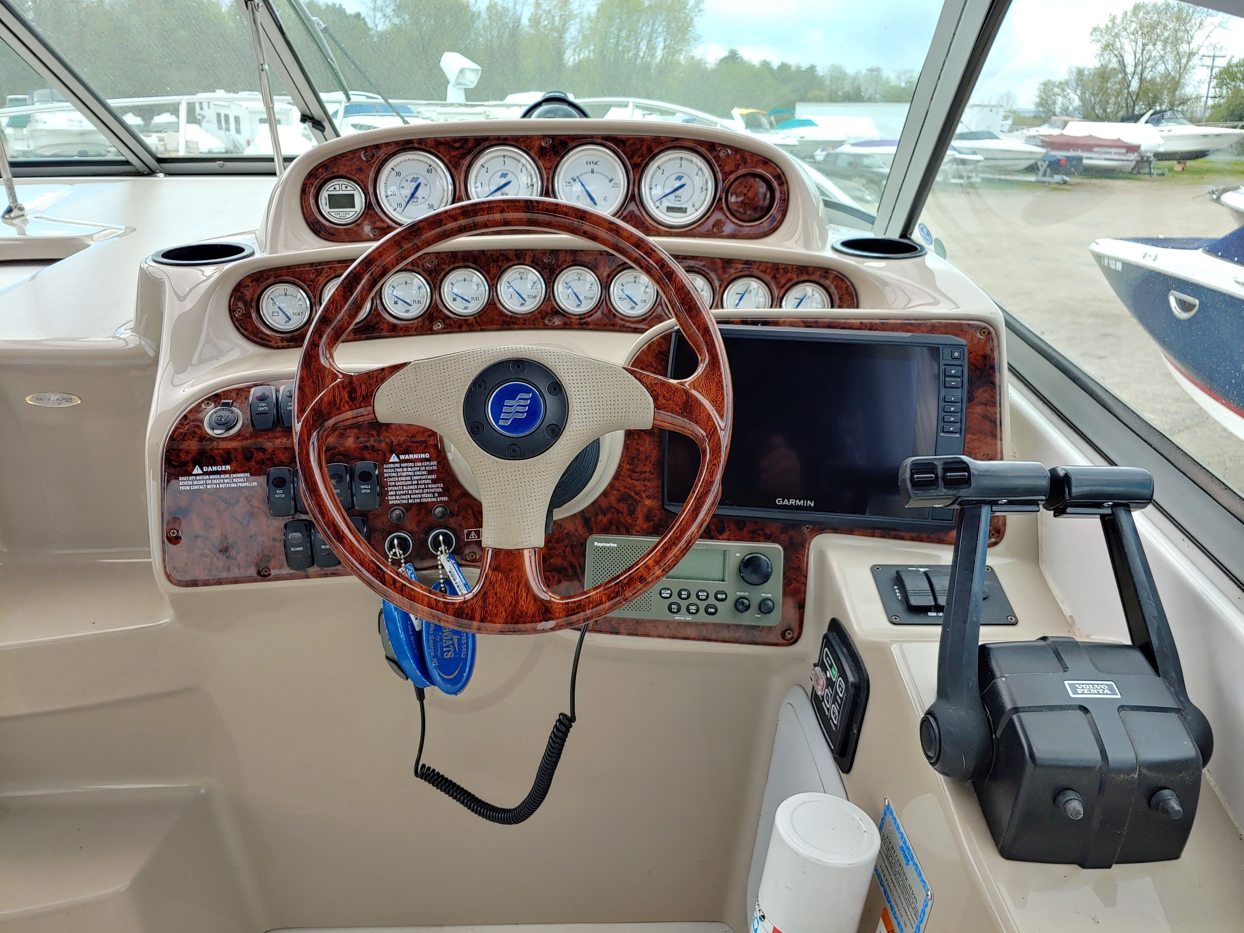The cockpit of a Four Winns 288 Vista boat with wood paneling and instruments.