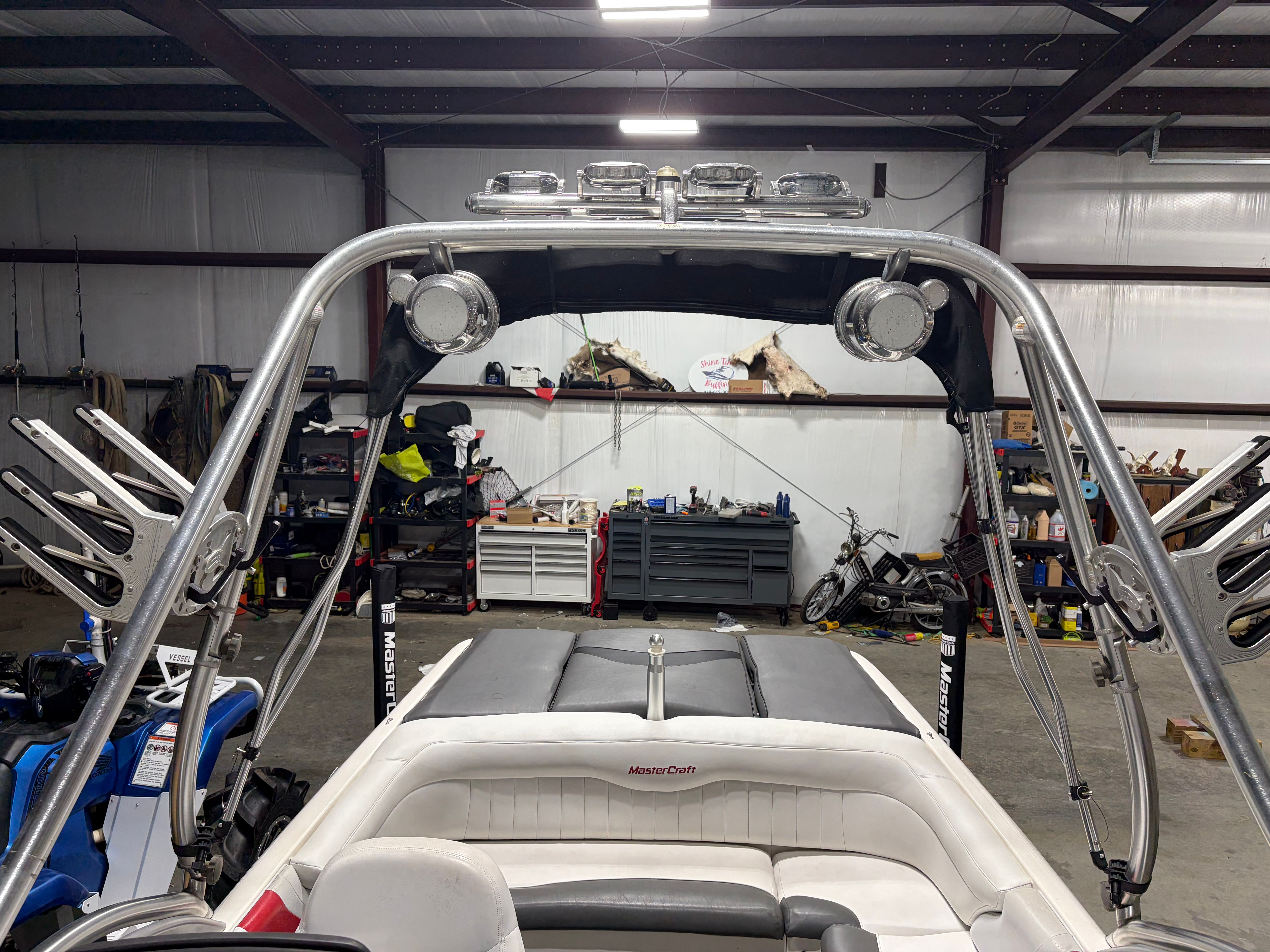 2004 MasterCraft X2 boat in a workshop with accessories.