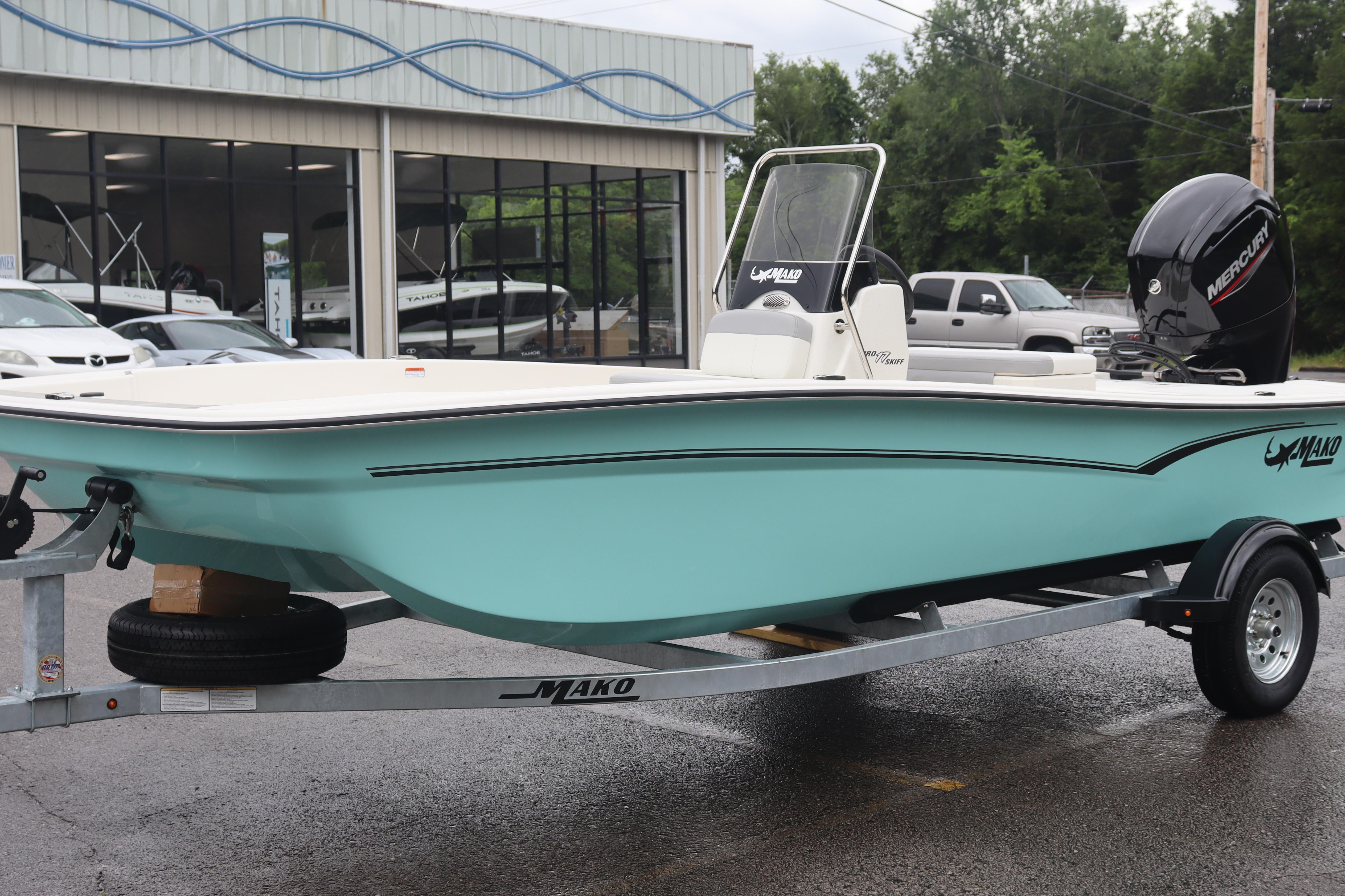 2026 Mako Pro Skiff 17 CC boat on trailer, displayed outdoors near dealership.