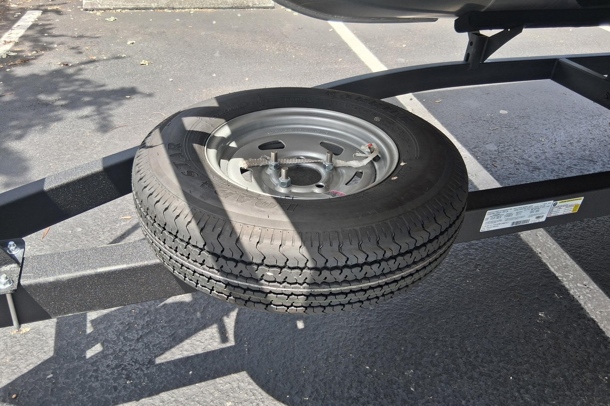 Spare tire mounted on a Sun Tracker SportFish 22 DLX trailer, 2026 model.