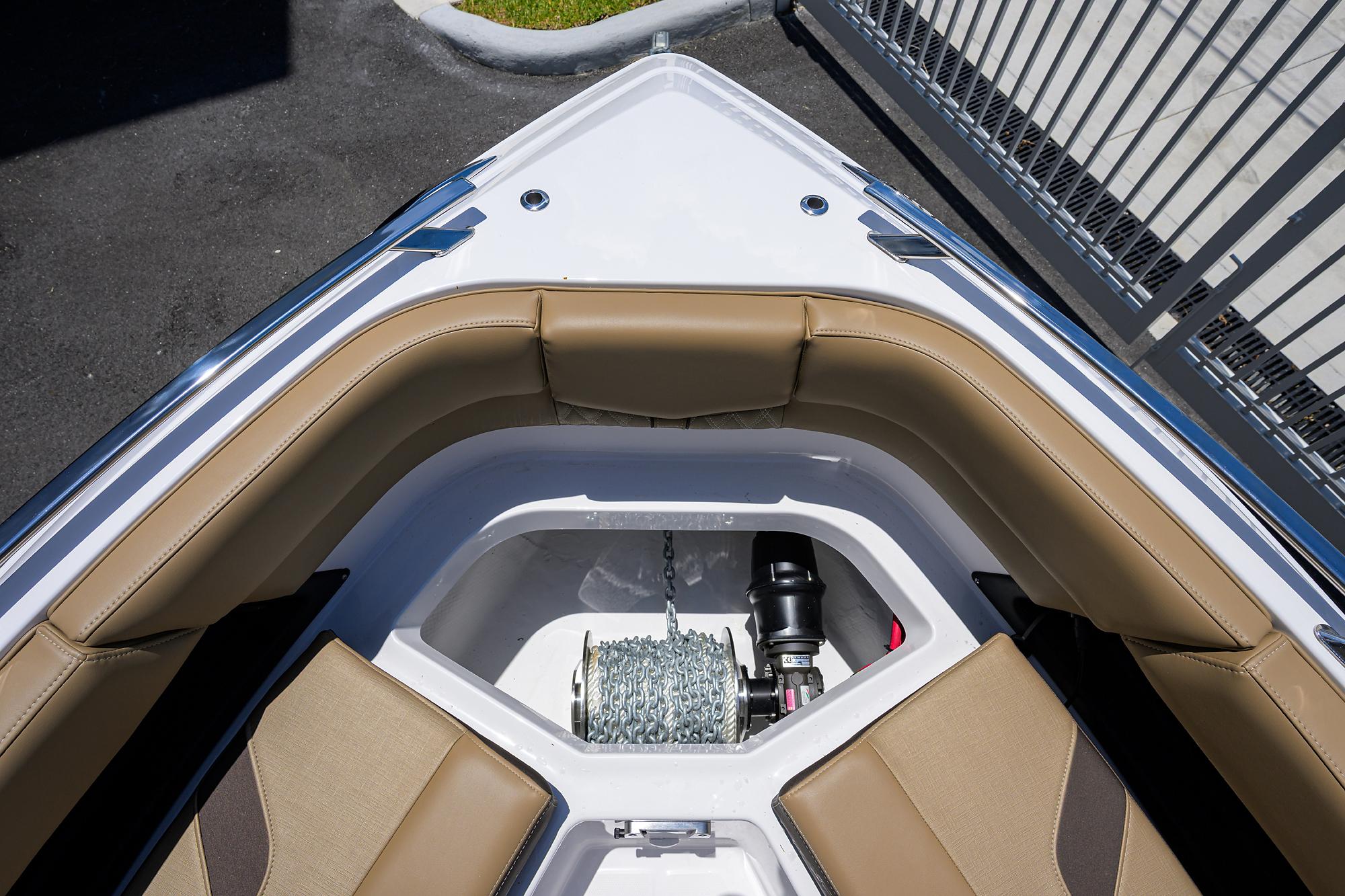 2026 Monterey Elite 27 OB boat bow with tan seating and anchor storage.