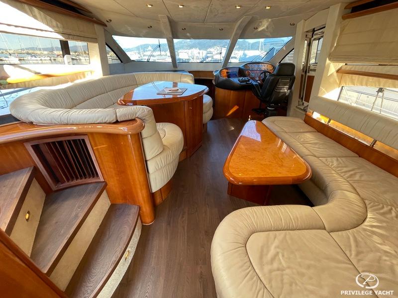 Luxurious interior of 2001 Sunseeker Manhattan 74 yacht with elegant seating and wooden accents.