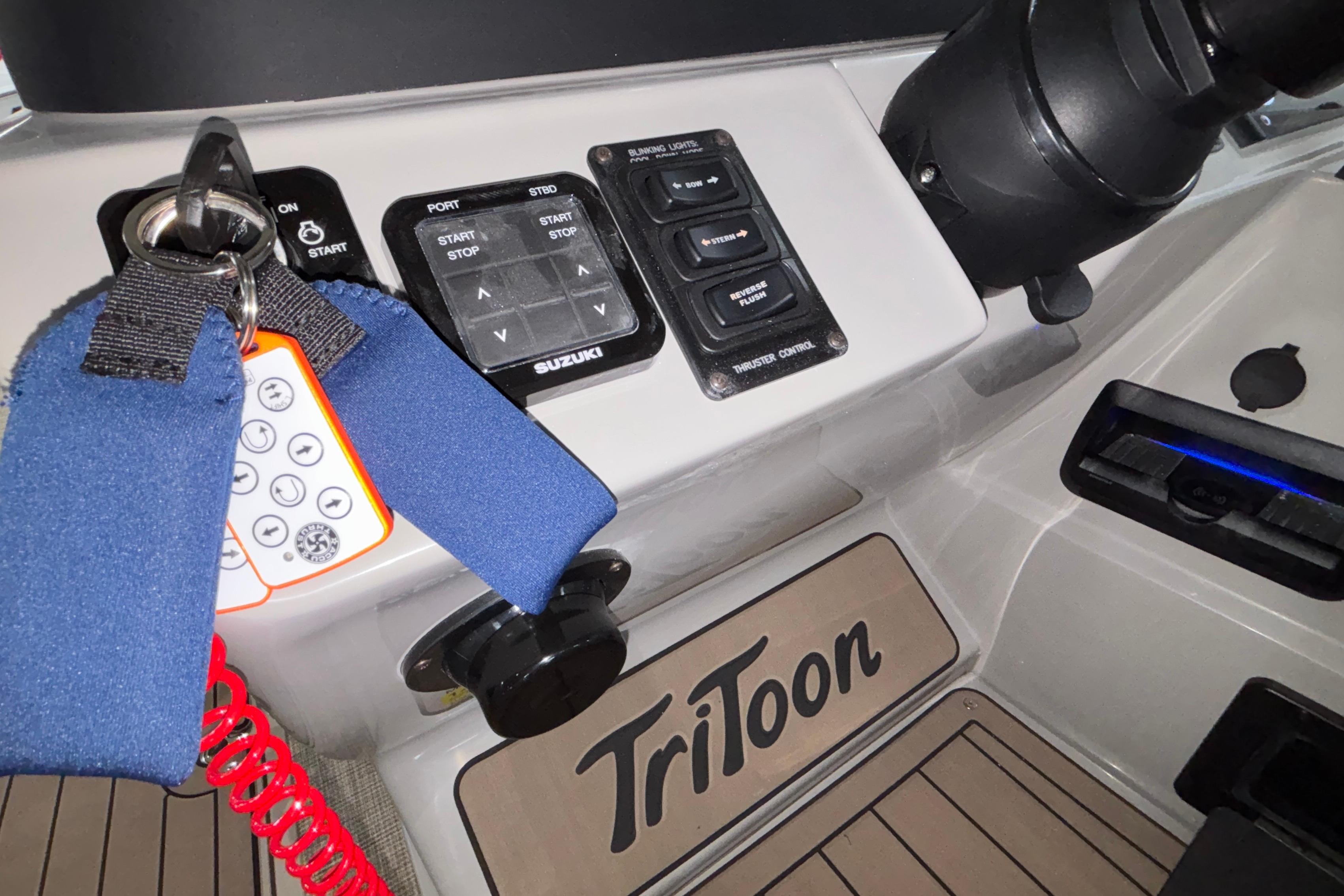 Control panel of 2026 JC Sporttoon 26TT boat with keys and switches.