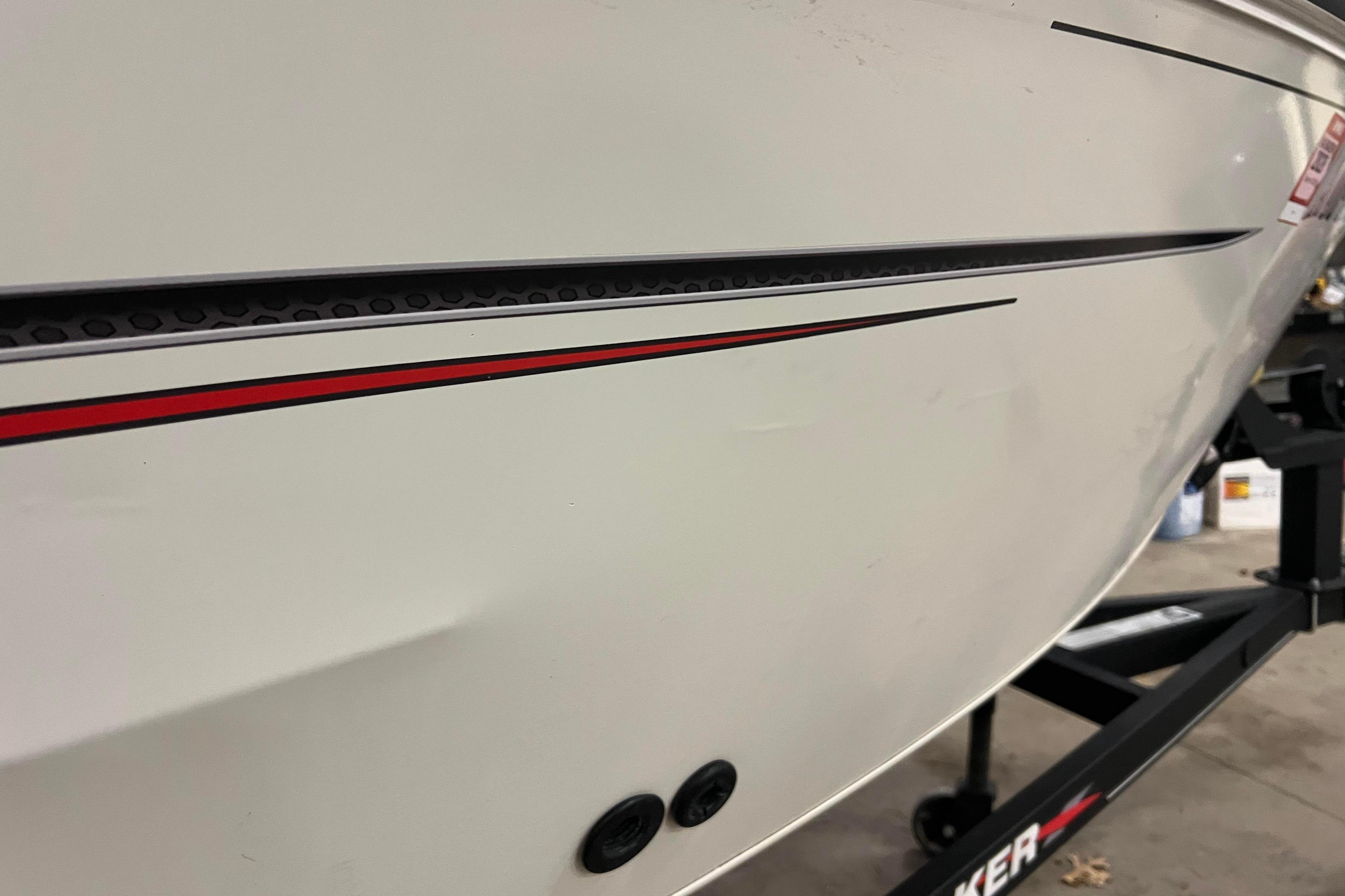 2022 Tracker Pro Guide V-16 WT boat with sleek red and black detailing.