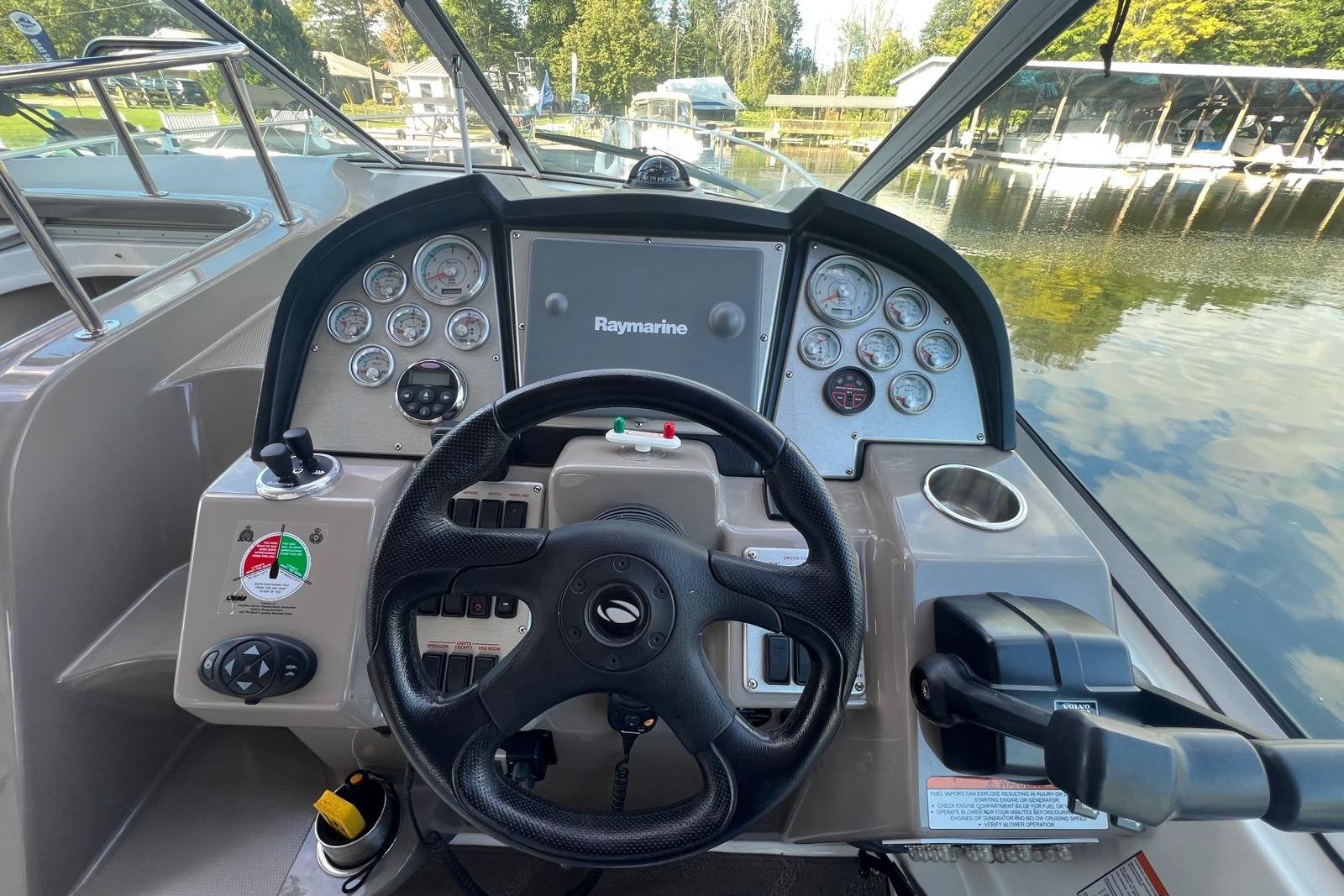 2008 Cruisers Yachts 330 Express helm with steering wheel and navigation controls.