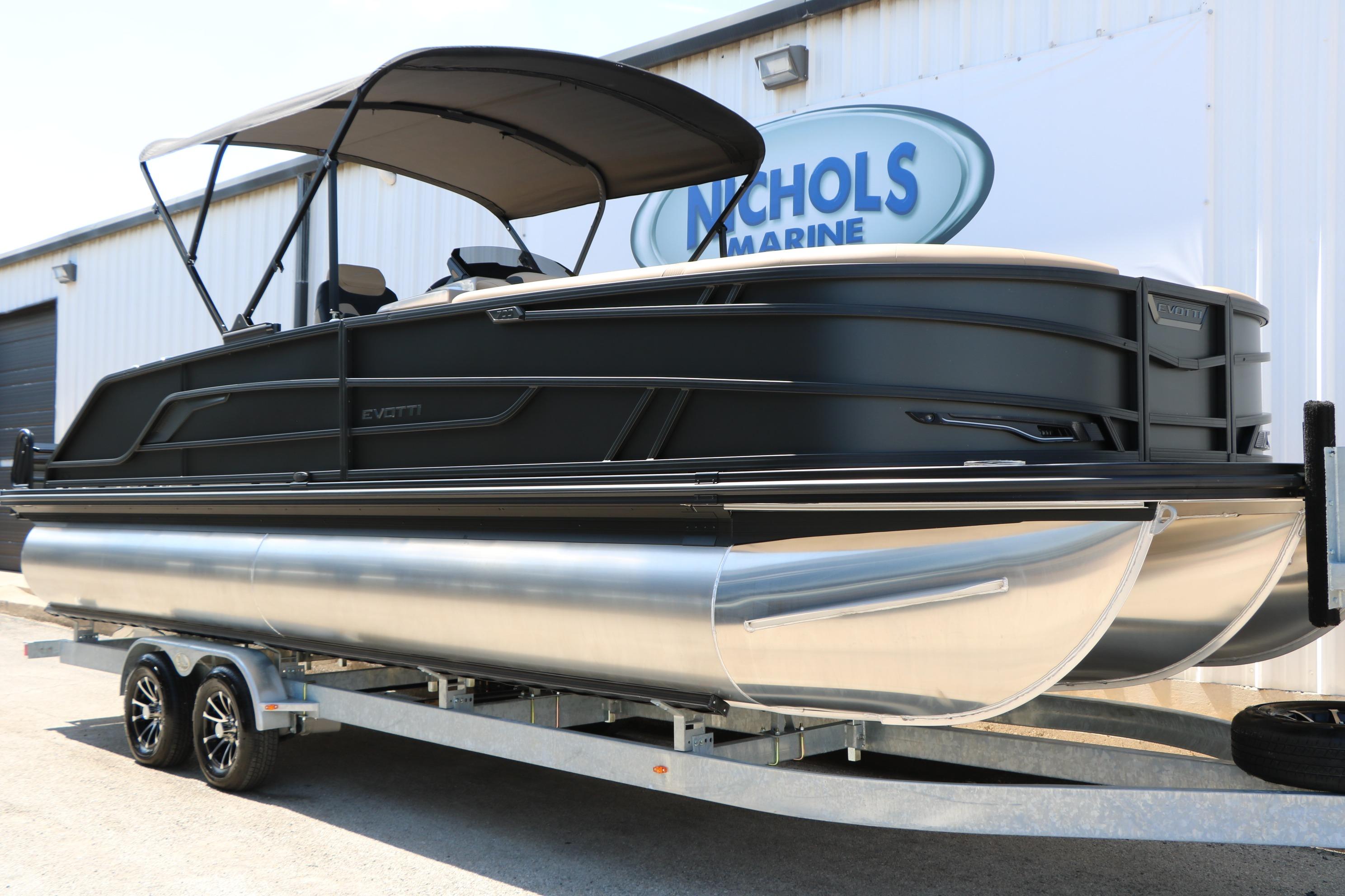 2026 Evotti 725 CS Tri-Toon boat on trailer at Nichols Marine dealership.