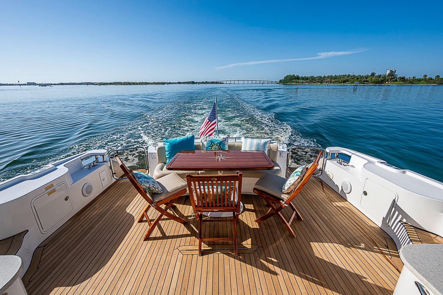 2008 Sea Ray 60 Sundancer yacht deck with chairs, table, and ocean view.
