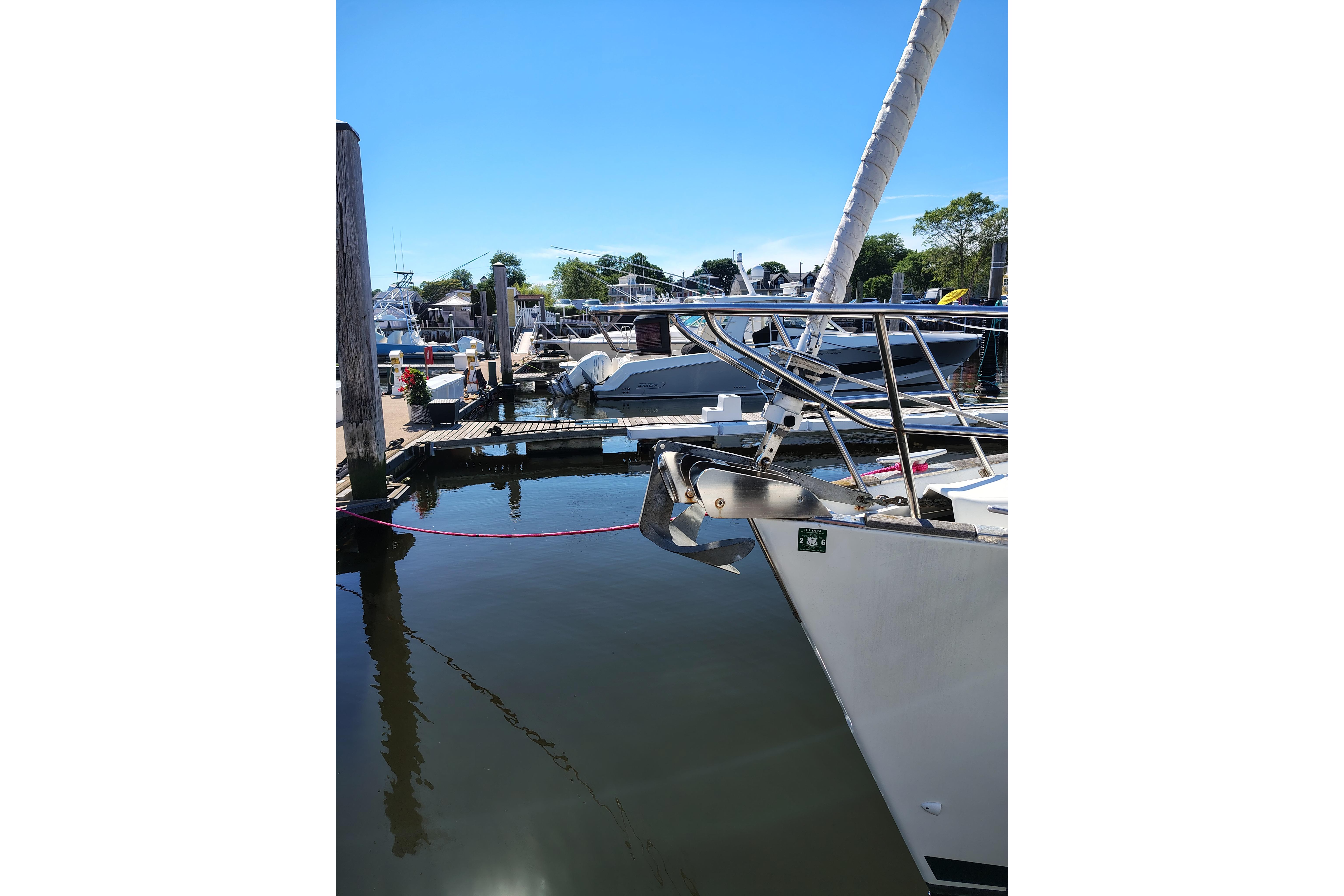 Beneteau Oceanis 411 sailboat docked at marina, clear blue sky, 2001 model.