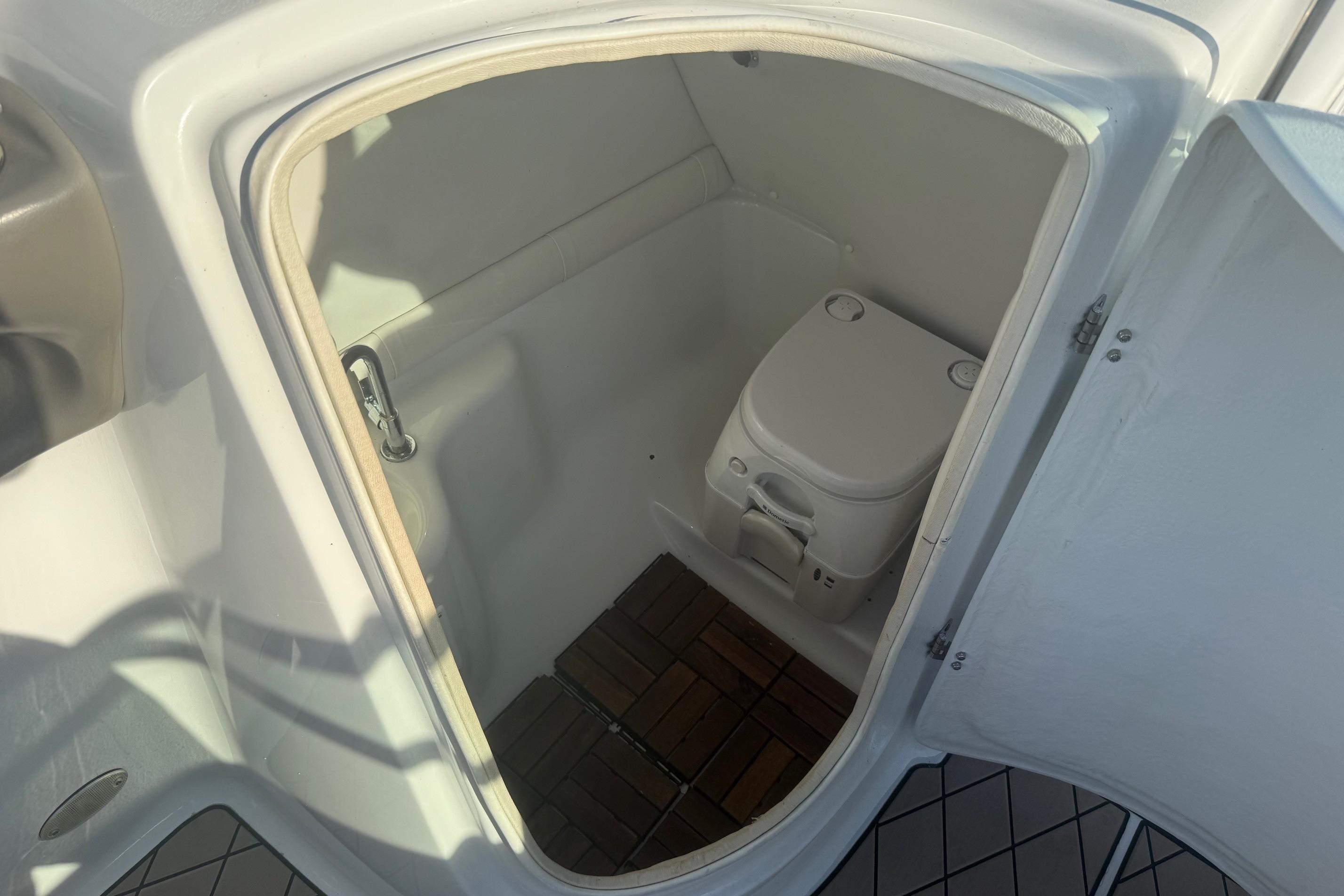 2005 Crownline 270 BR boat interior with compact marine toilet.
