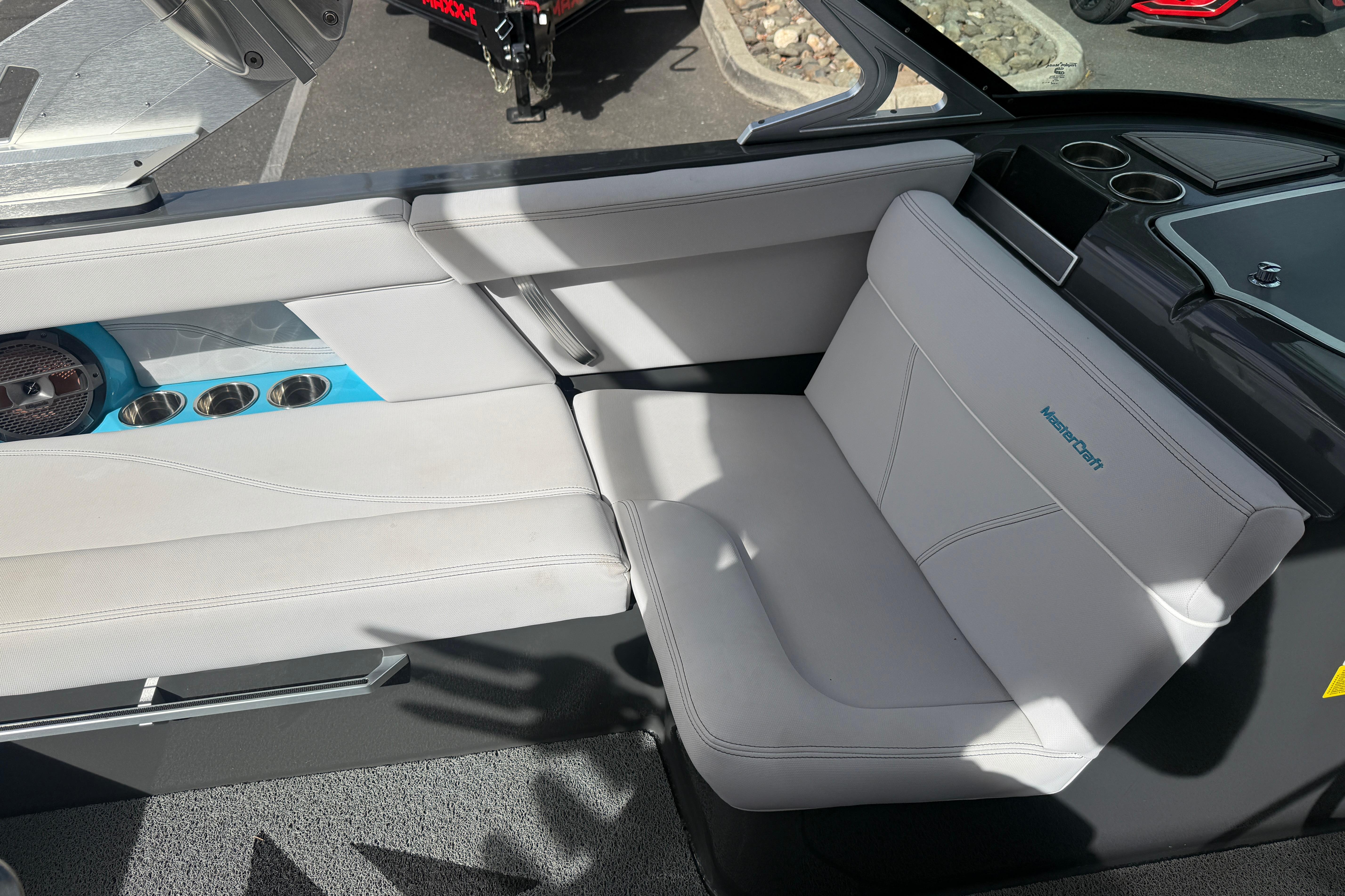 Interior of a 2018 MasterCraft XT21 boat with white seating and cup holders.