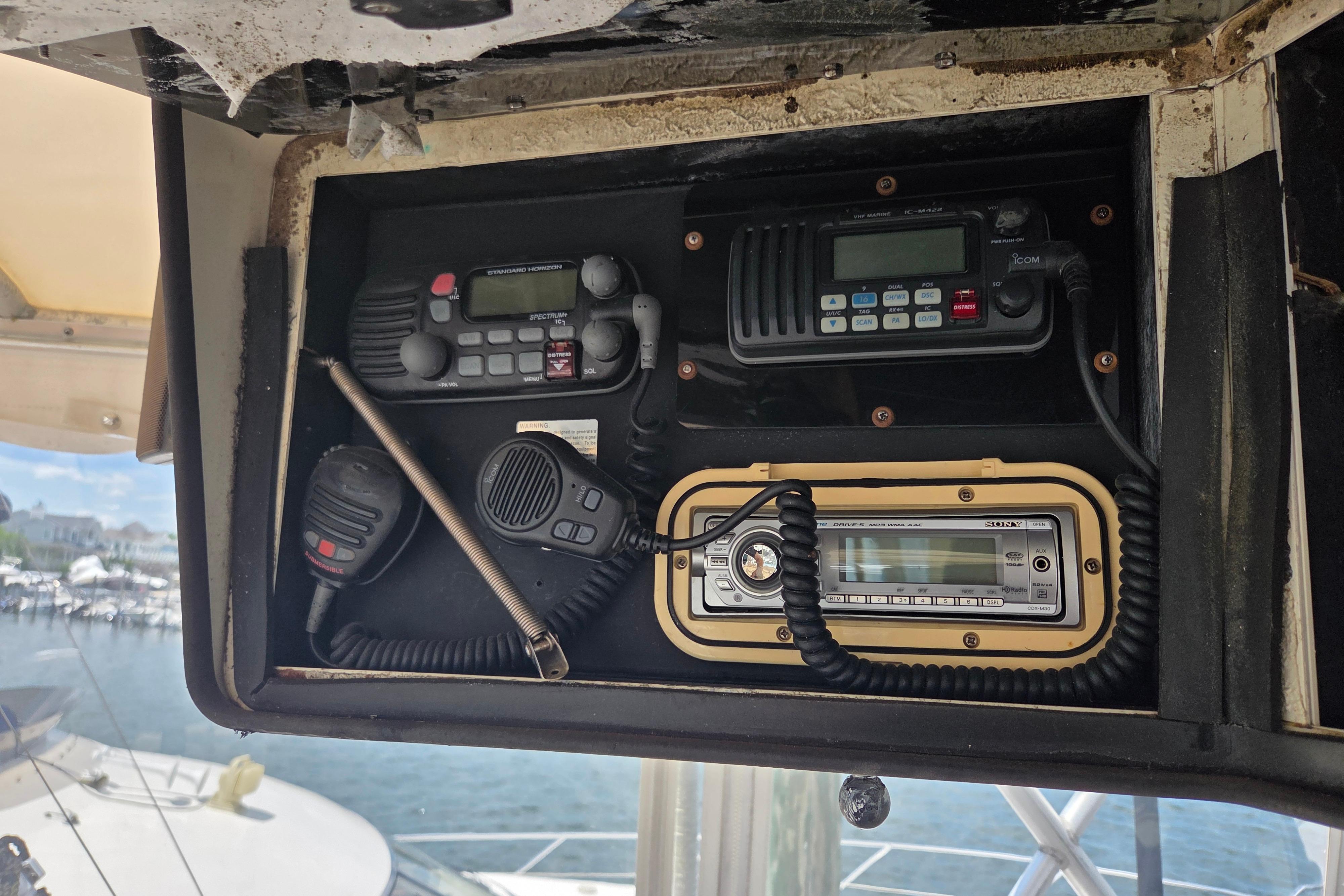 Control panel of a 1990 Egg Harbor Golden Egg 42 boat with communication devices.