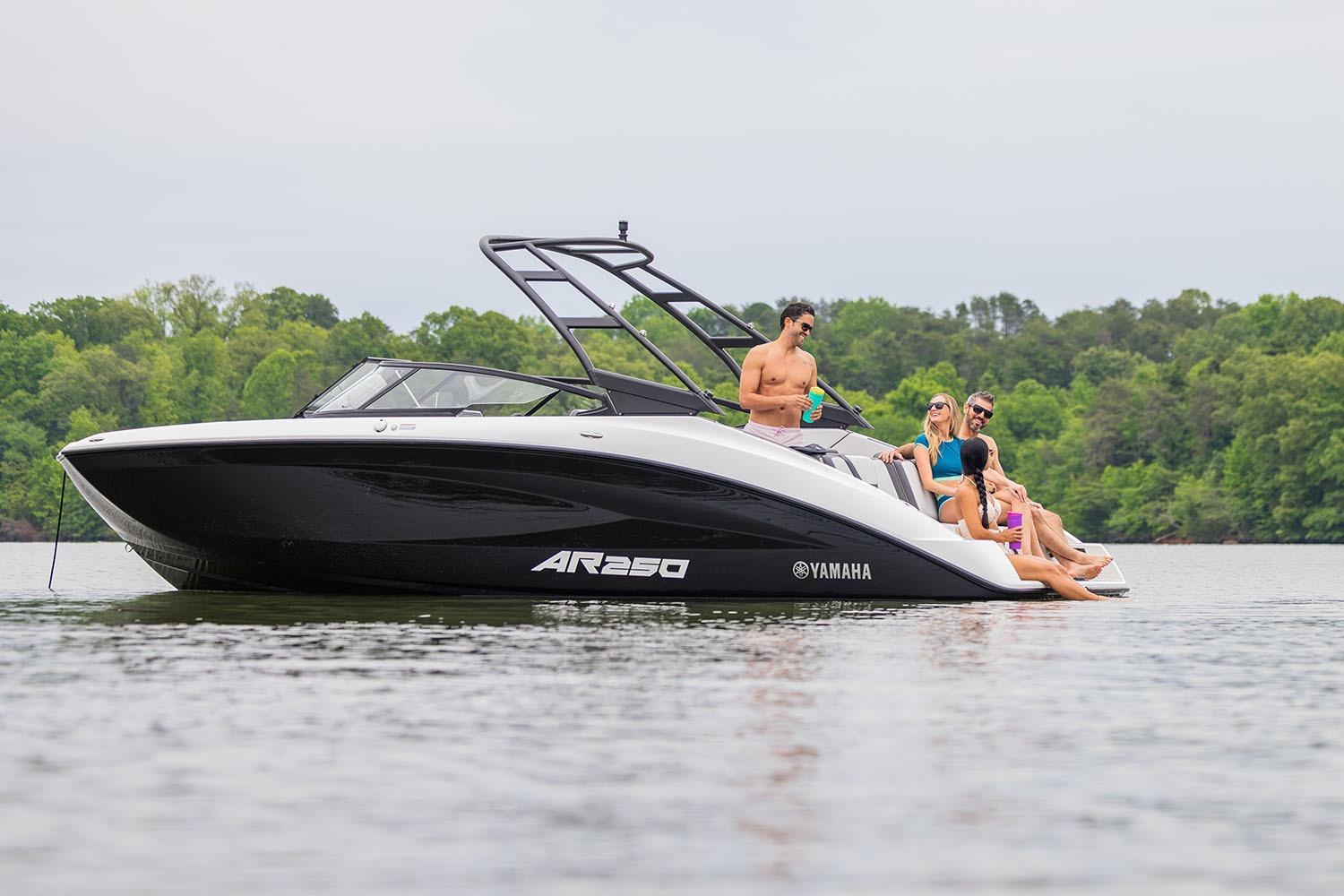 Manufacturer Provided Image: 2026 Yamaha Boats AR250 on a lake with people relaxing onboard.