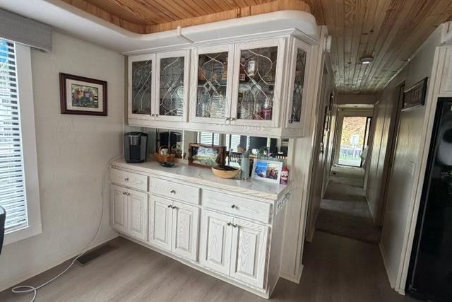 Interior of 1997 Stardust Houseboat 18x83 with wooden cabinets and decorative glass doors.