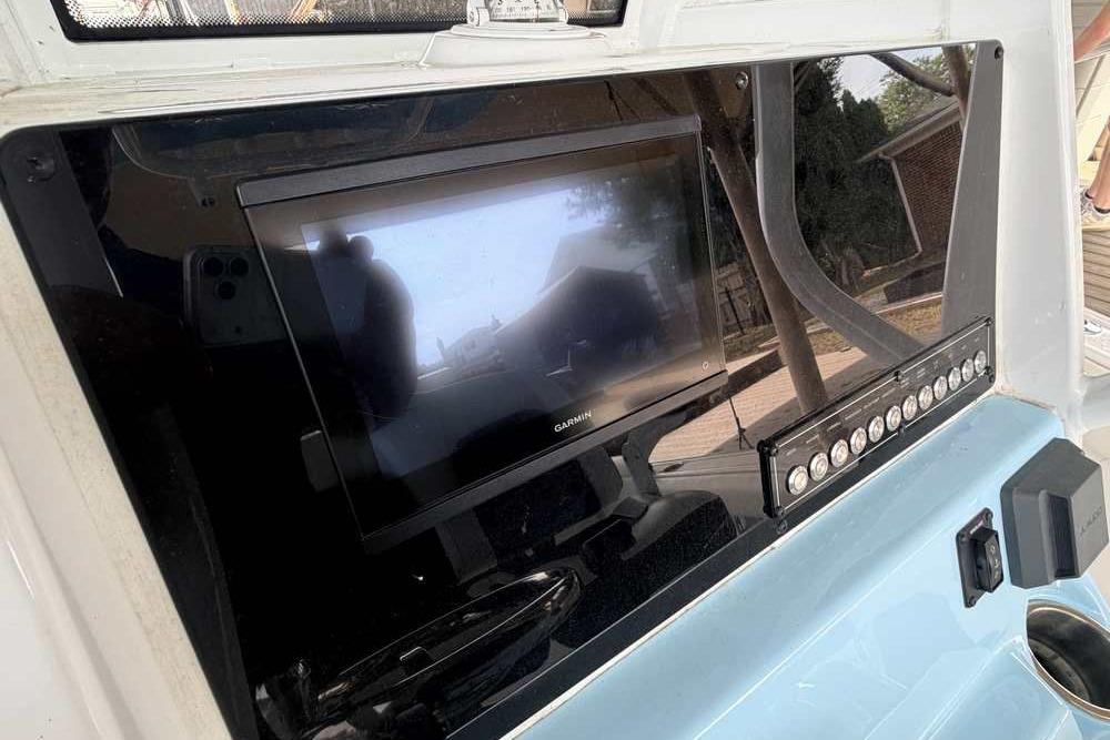 2024 Tidewater 232 LXF boat dashboard with Garmin display and control panel.