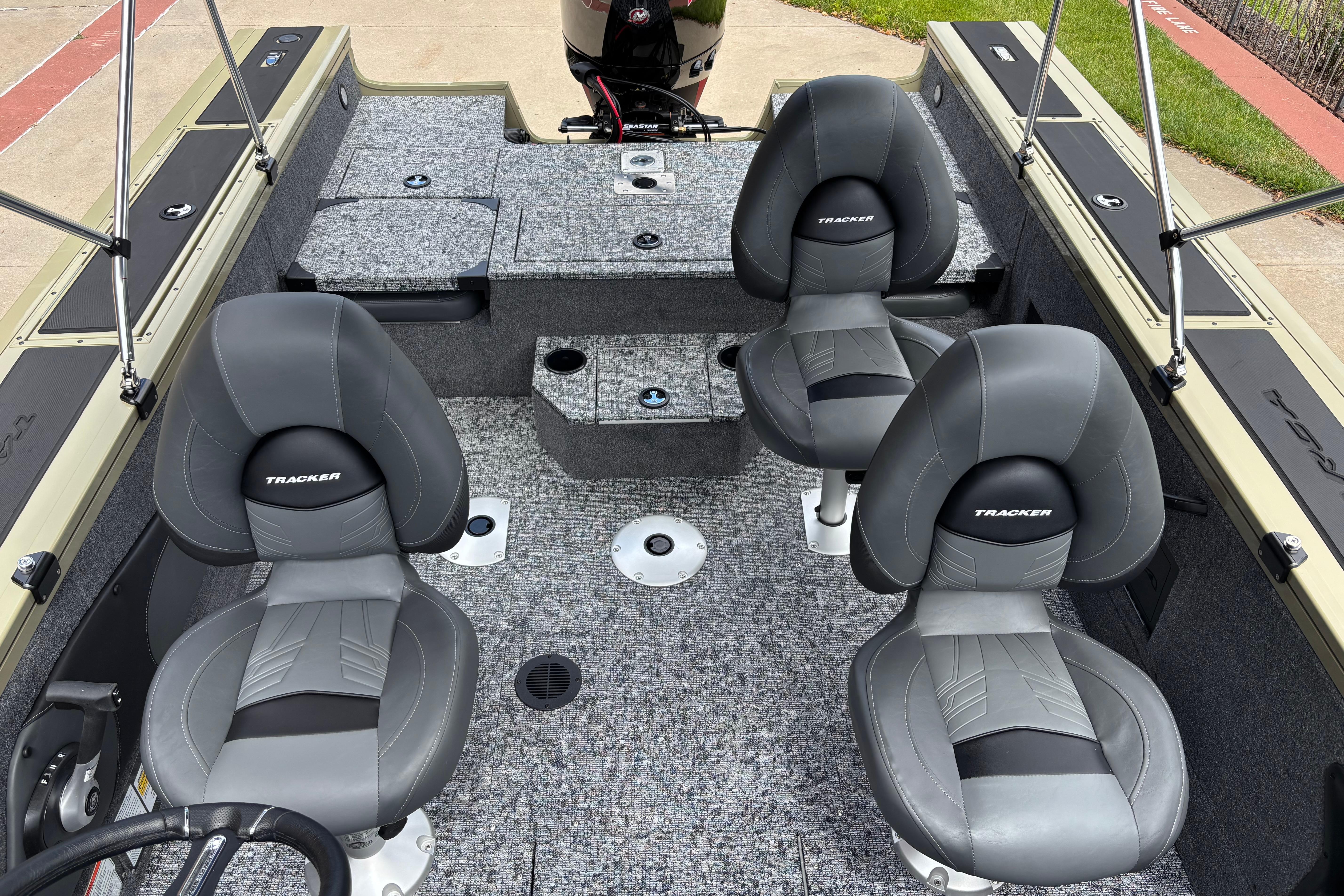 2026 Tracker Targa V-18 Combo boat interior with four gray seats and carpeted flooring.