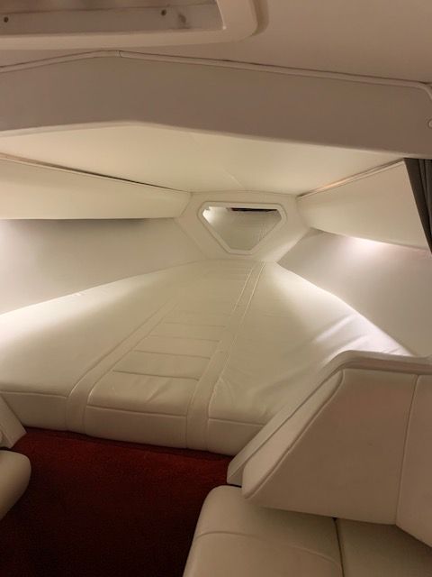 Interior of a 2001 Fountain Lightning yacht with white upholstery.