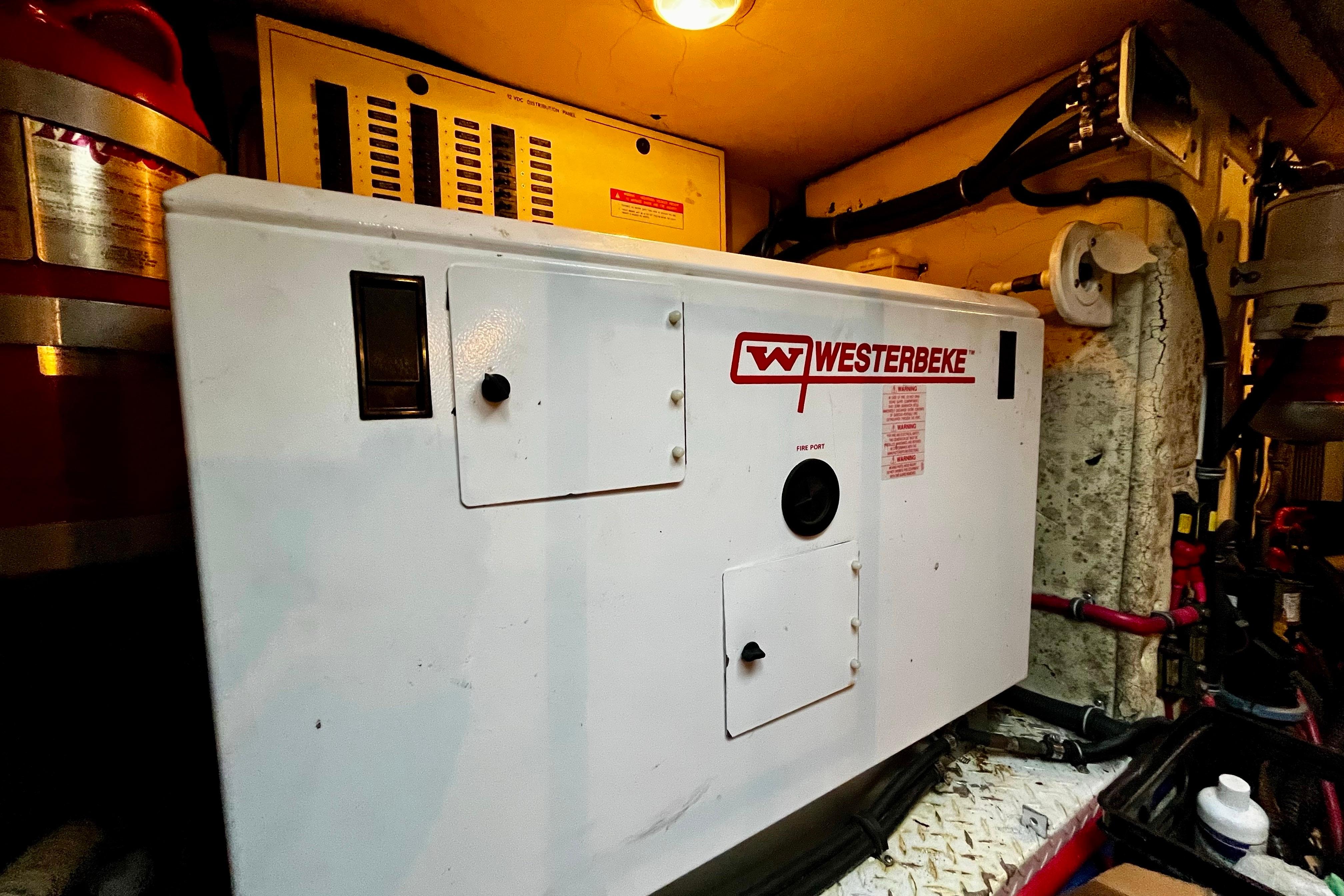 Westerbeke generator in 2008 Formula 45 Yacht engine room, illuminated and surrounded by equipment.