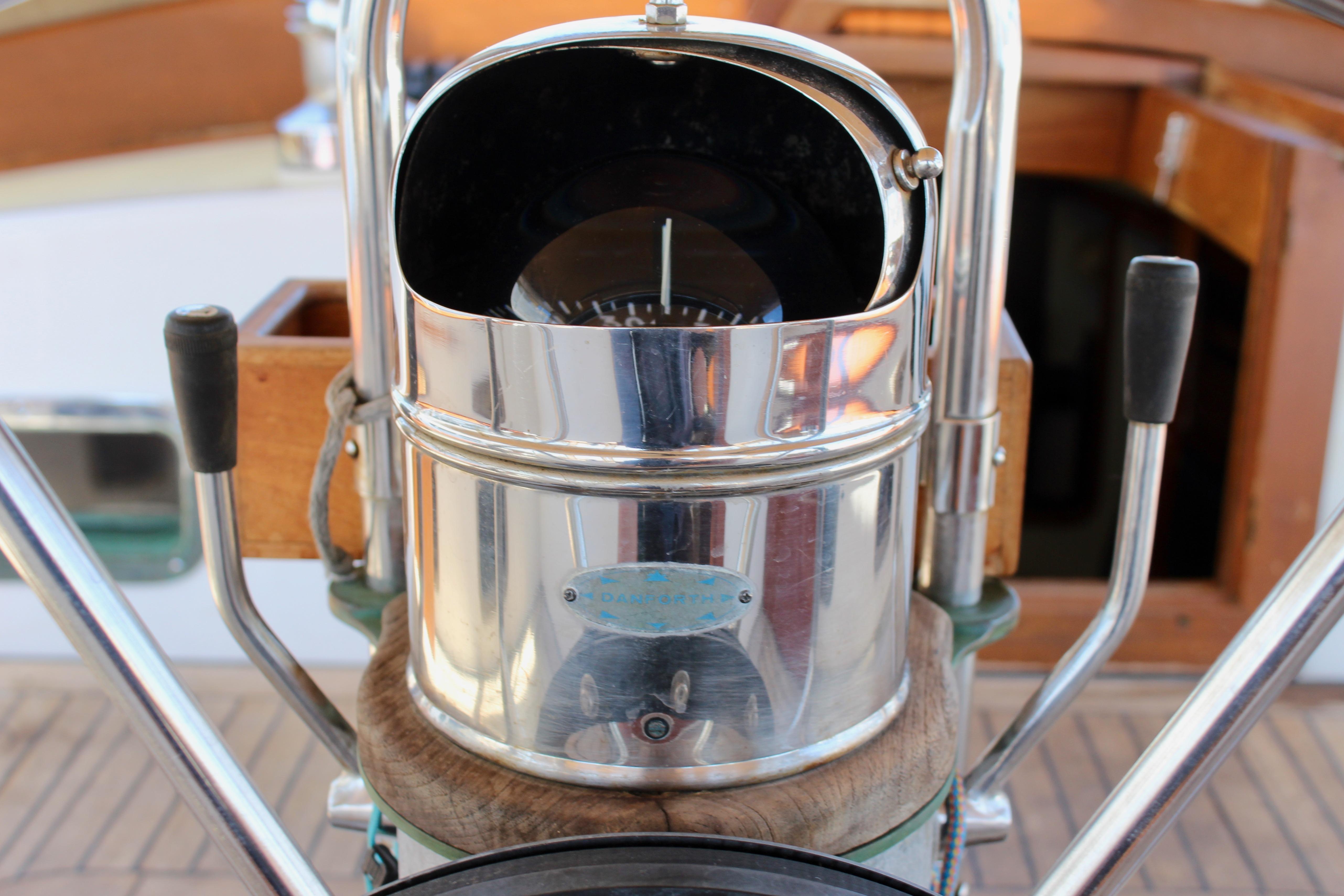 Compass on a 1981 Kelly Peterson 46 sailboat, featuring polished metal and wooden accents.