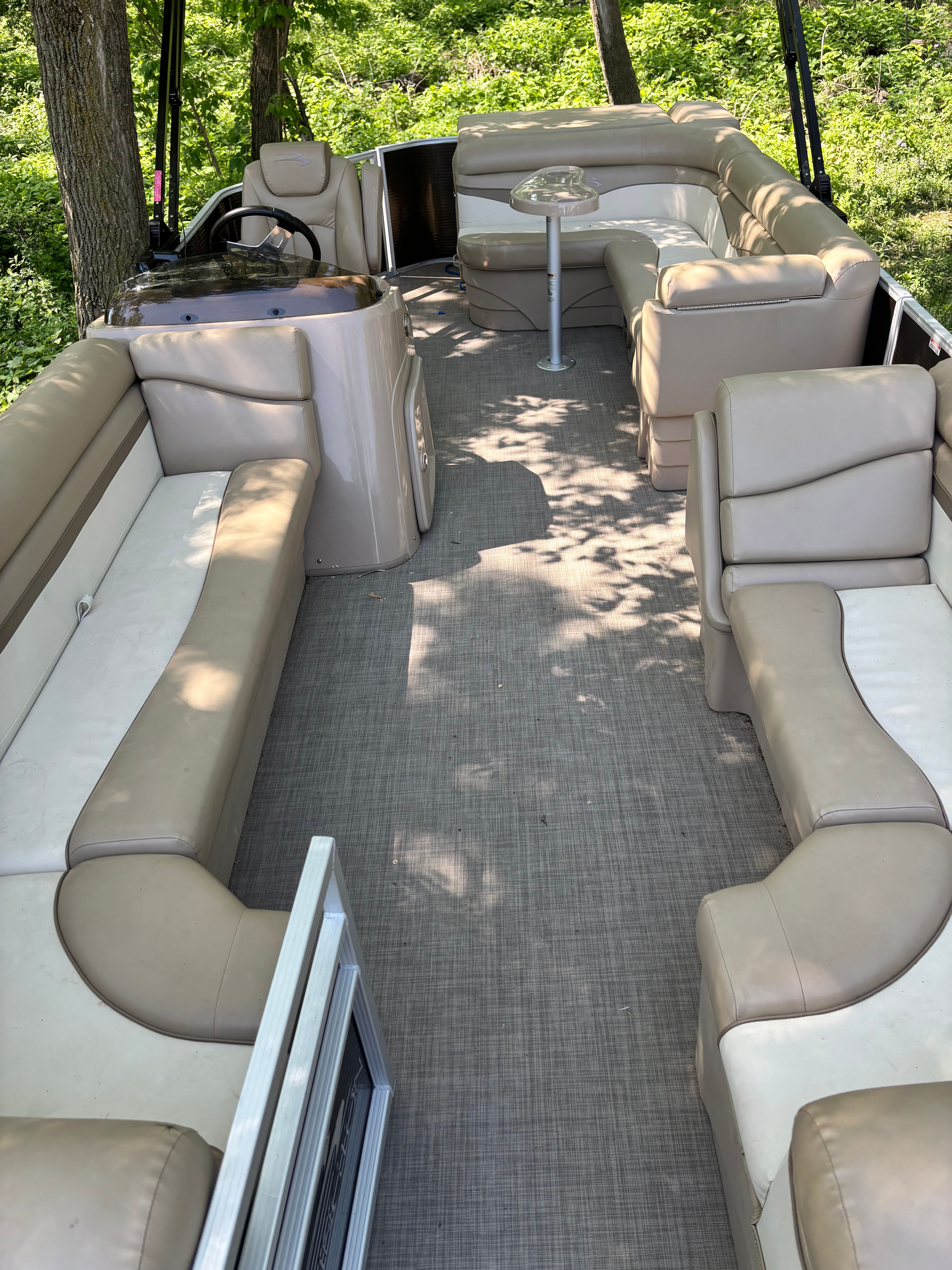 Interior of a 2016 Bennington 22 SLX pontoon boat with beige seating.