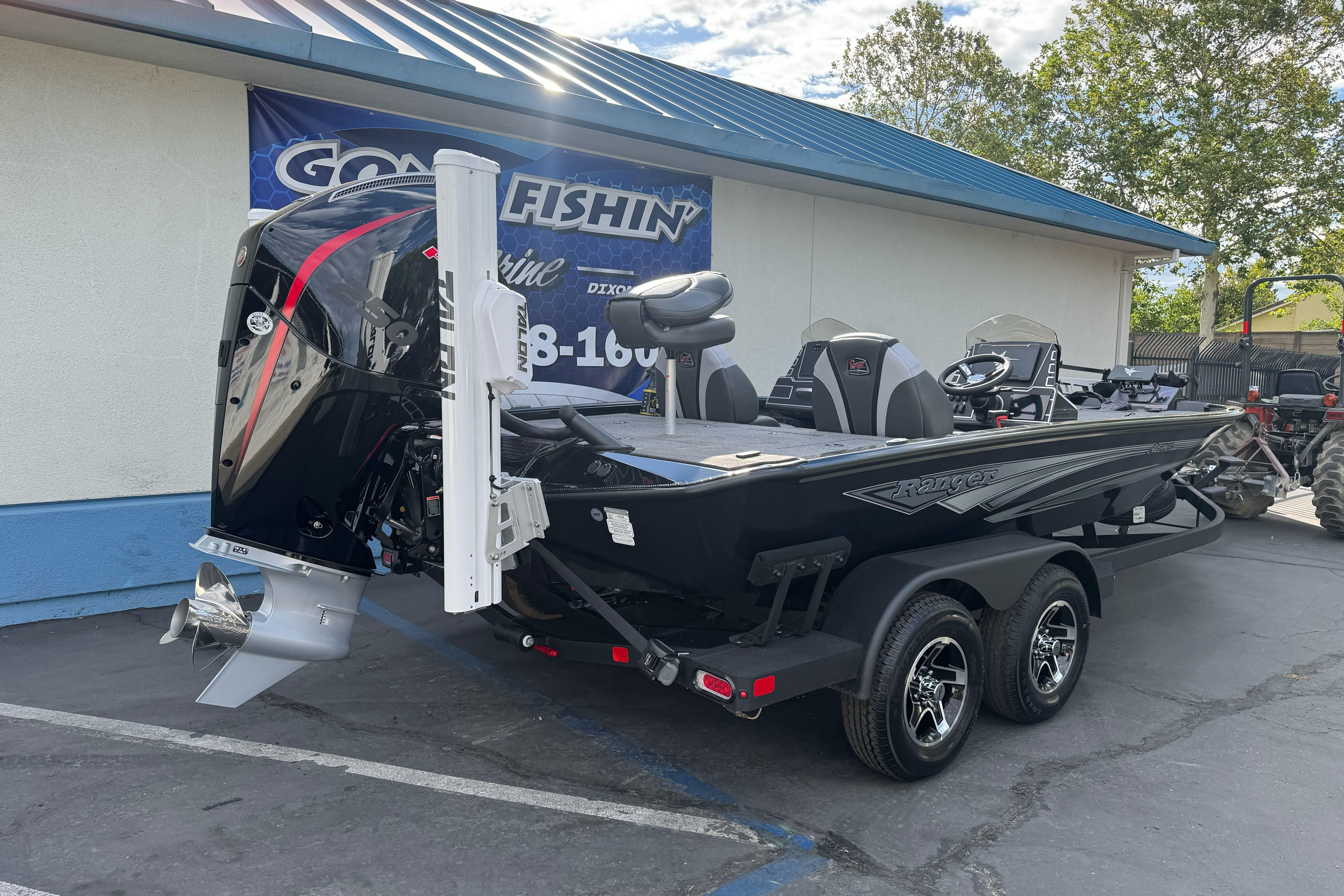 2026 Ranger ALPHA 208 boat on trailer, parked outside a marine shop.