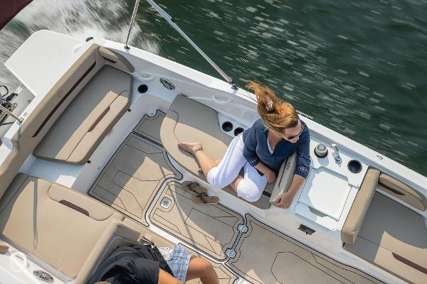 2025 Hurricane SunDeck Sport 205 OB boat interior with passengers on water.