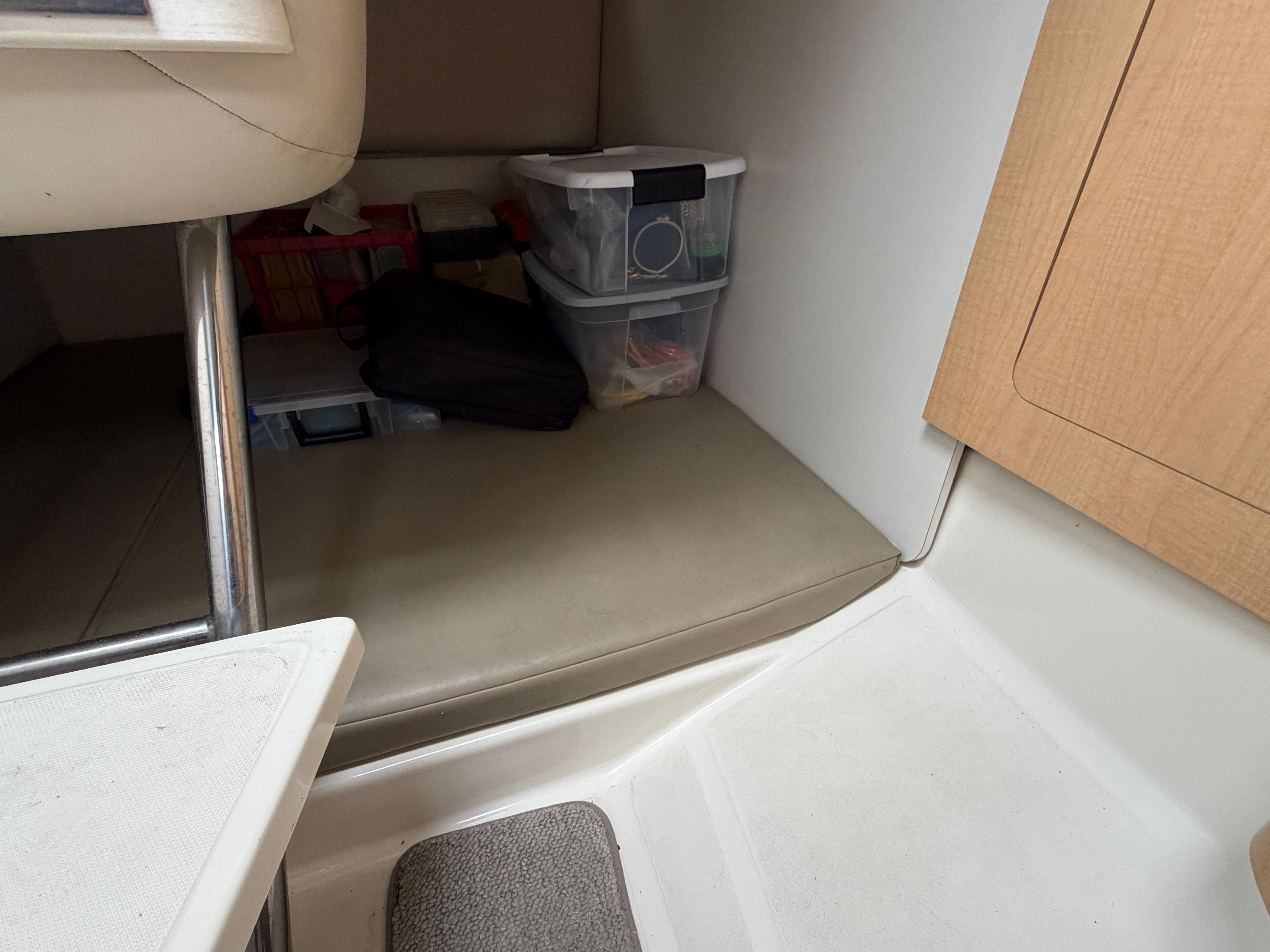 Interior of a Boston Whaler 26 Conquest with storage and seating area.
