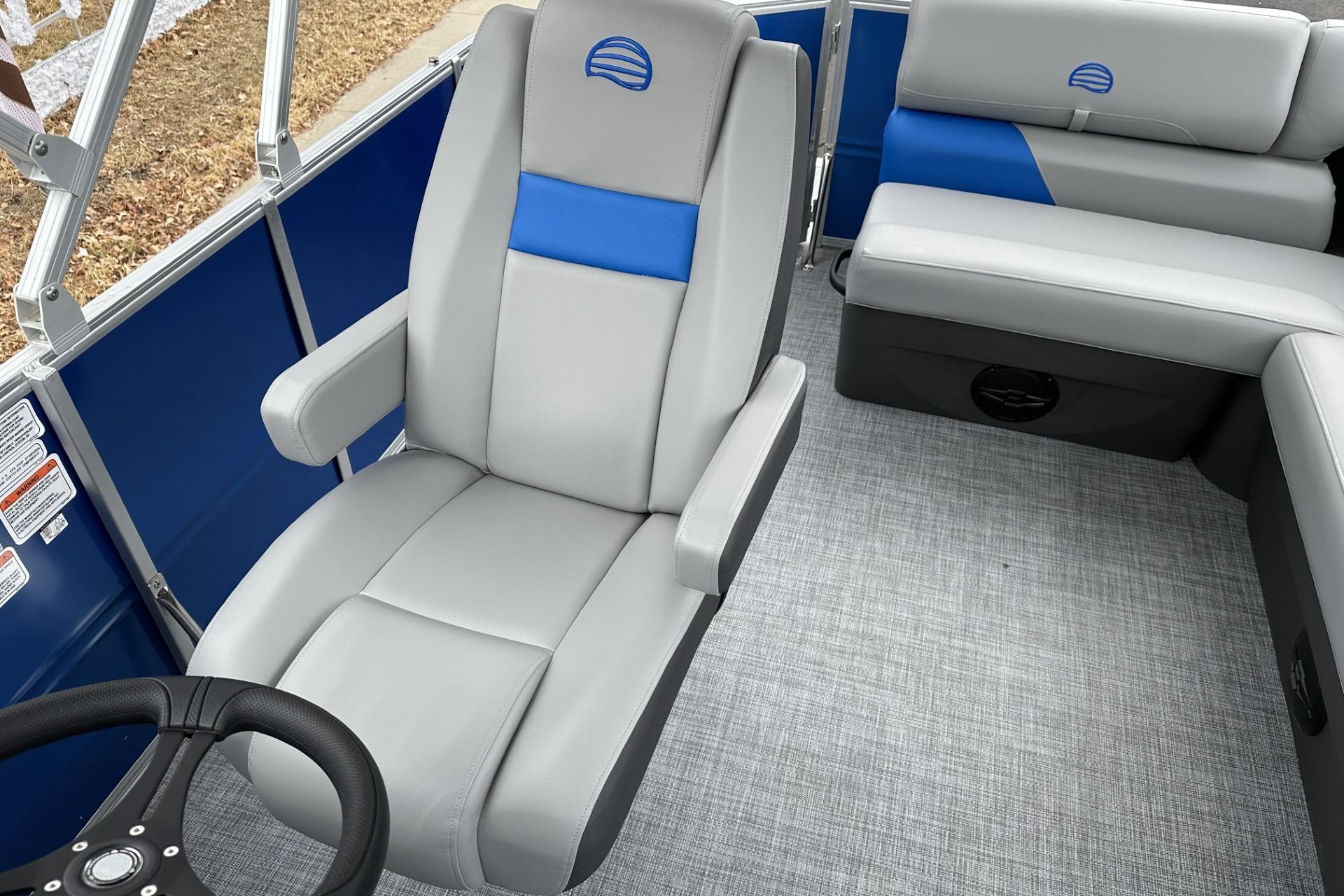 2026 Sun Tracker Party Barge 20 DLX interior with gray and blue seating.