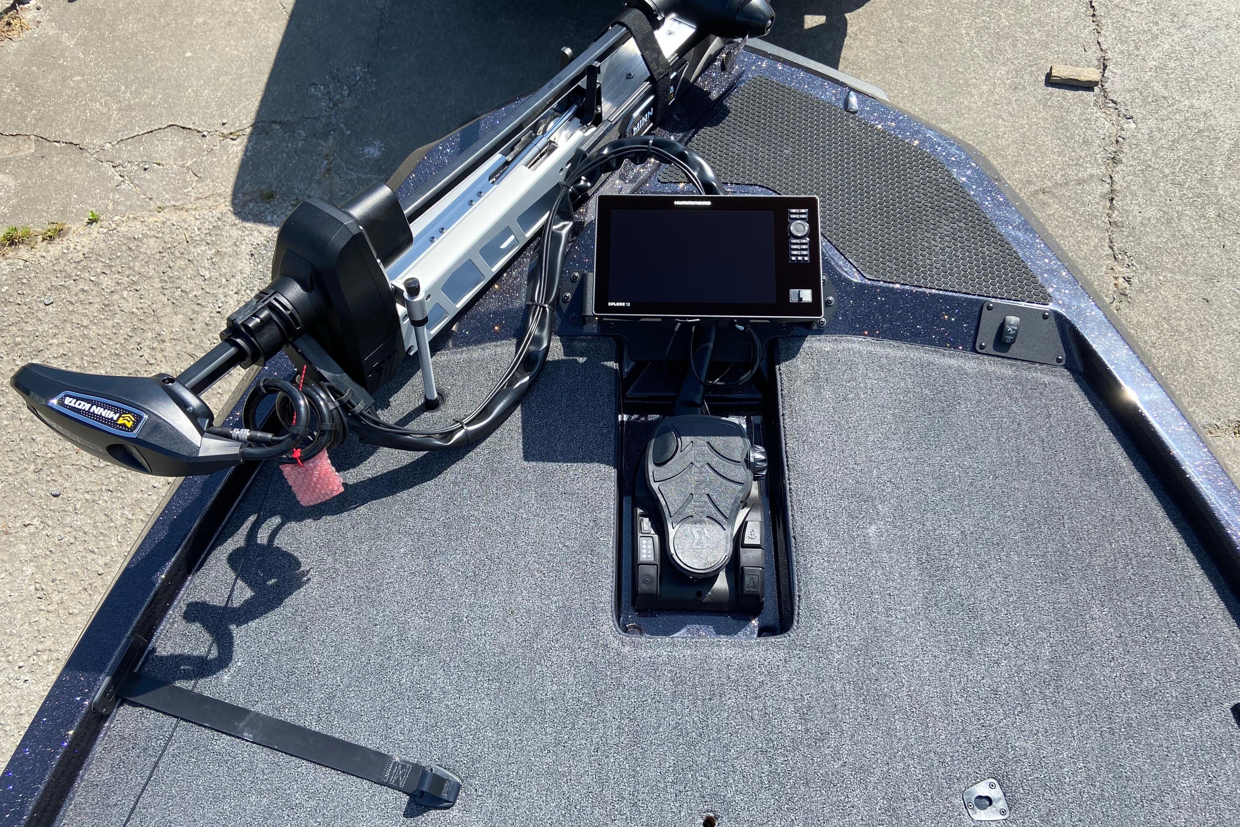 Fishing boat deck with advanced electronics and trolling motor, iKon VLX 21, 2026 model.