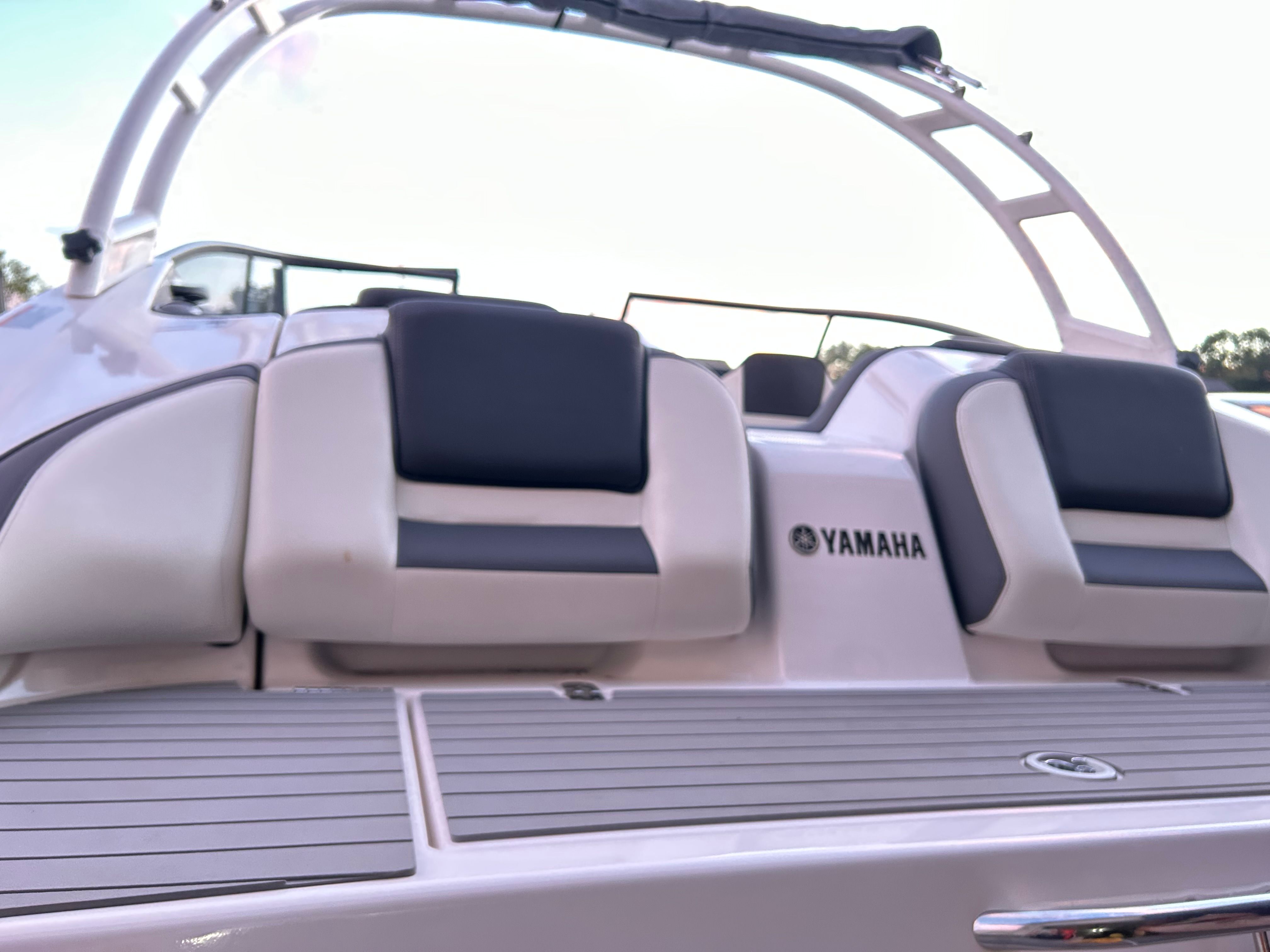 The image shows the rear of a Yamaha AR210 boat with cushioned seats.