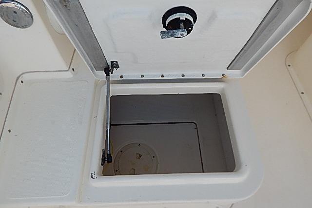 Open storage compartment on a 2003 World Cat 270 EC boat.