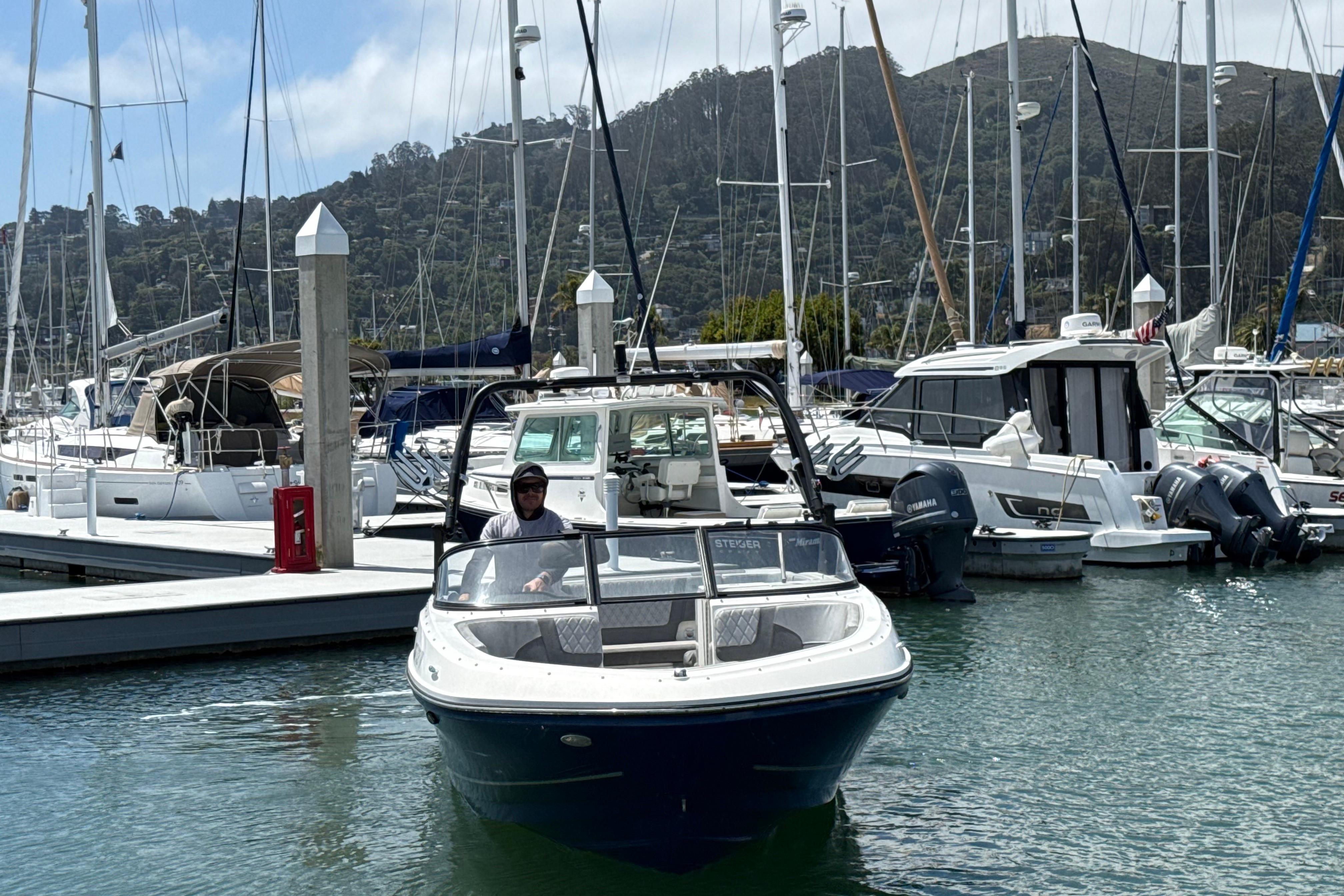 2021 Bayliner VR5 Bowrider I/O in marina, surrounded by sailboats and yachts.