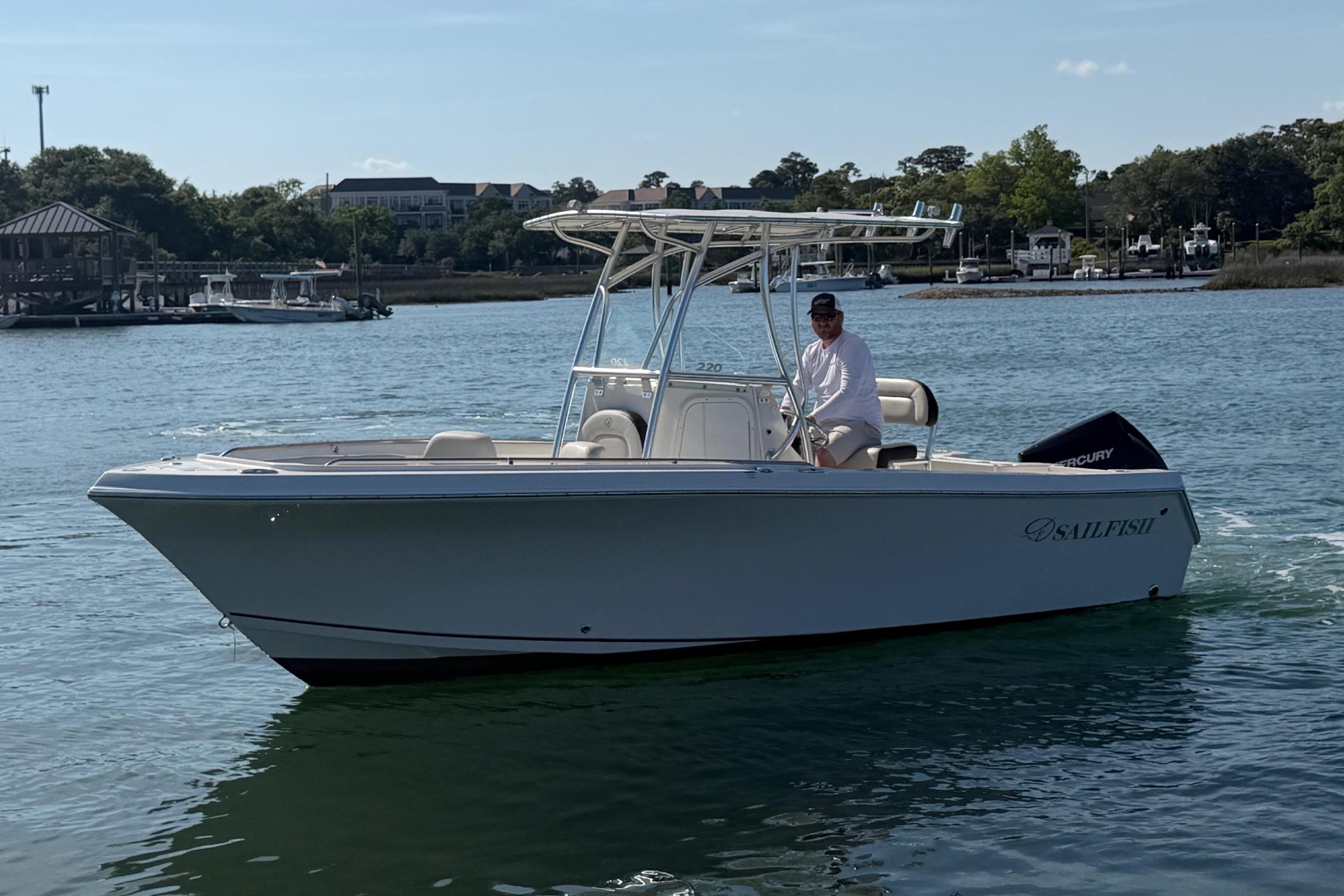 2023 Sailfish 220 CC boat on calm water.