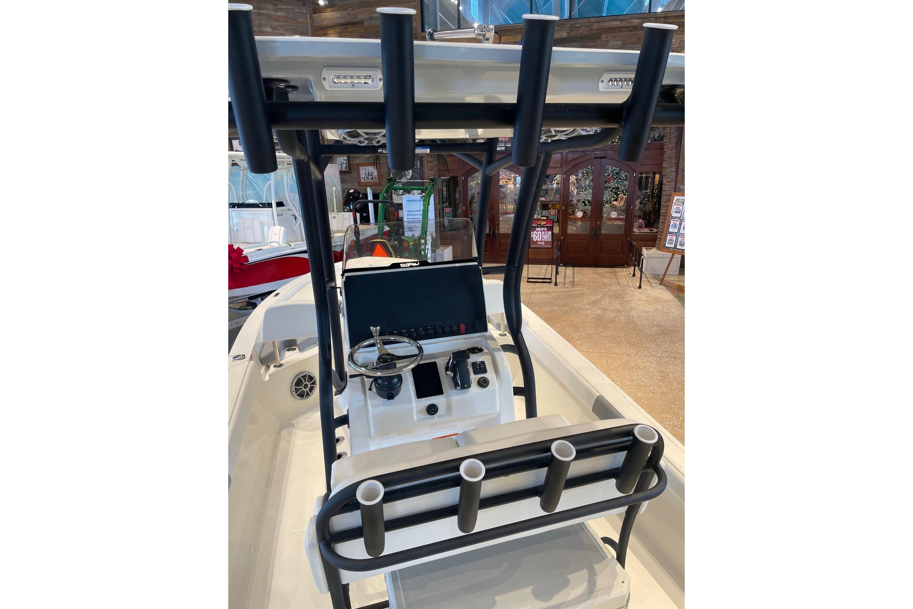 2026 Mako 24 APEX boat interior with steering console and rod holders.