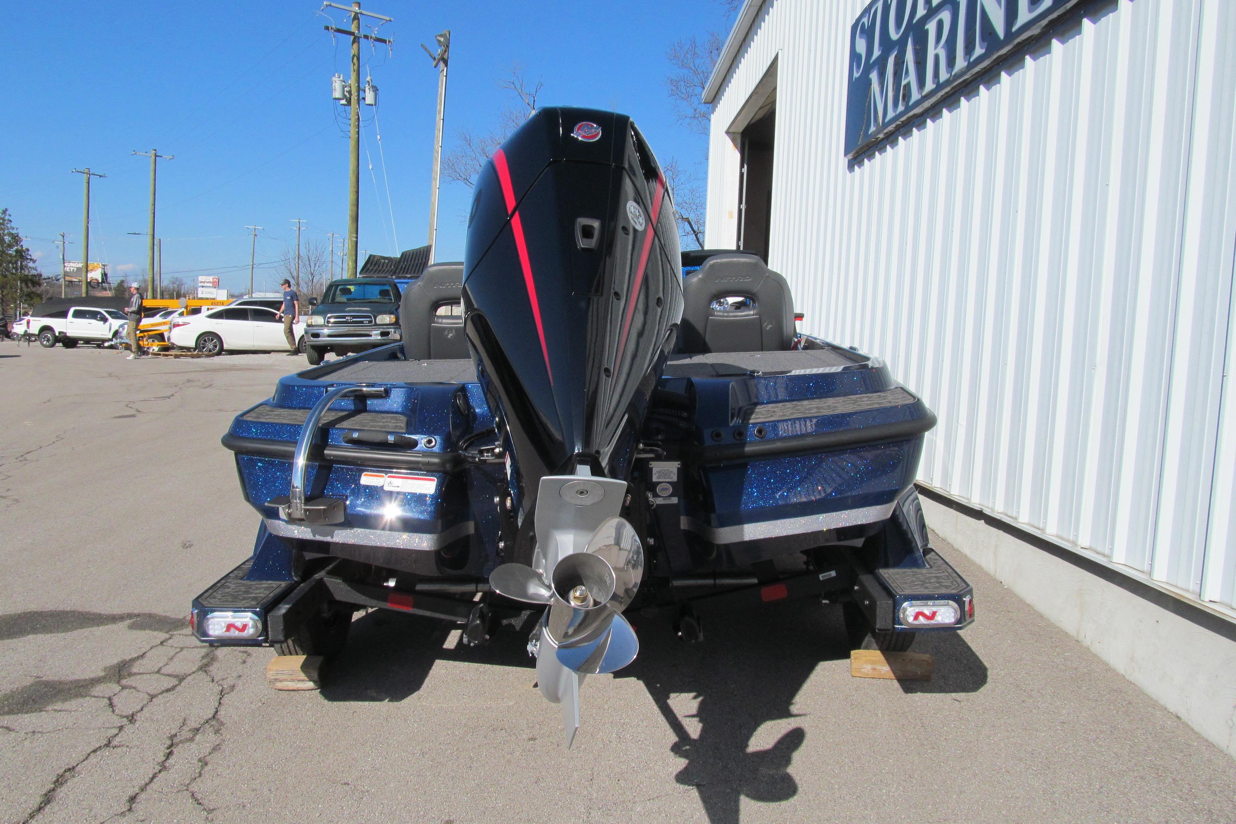 2026 Nitro Z20 XL Pro boat with powerful outboard motor, parked outside a marine store.