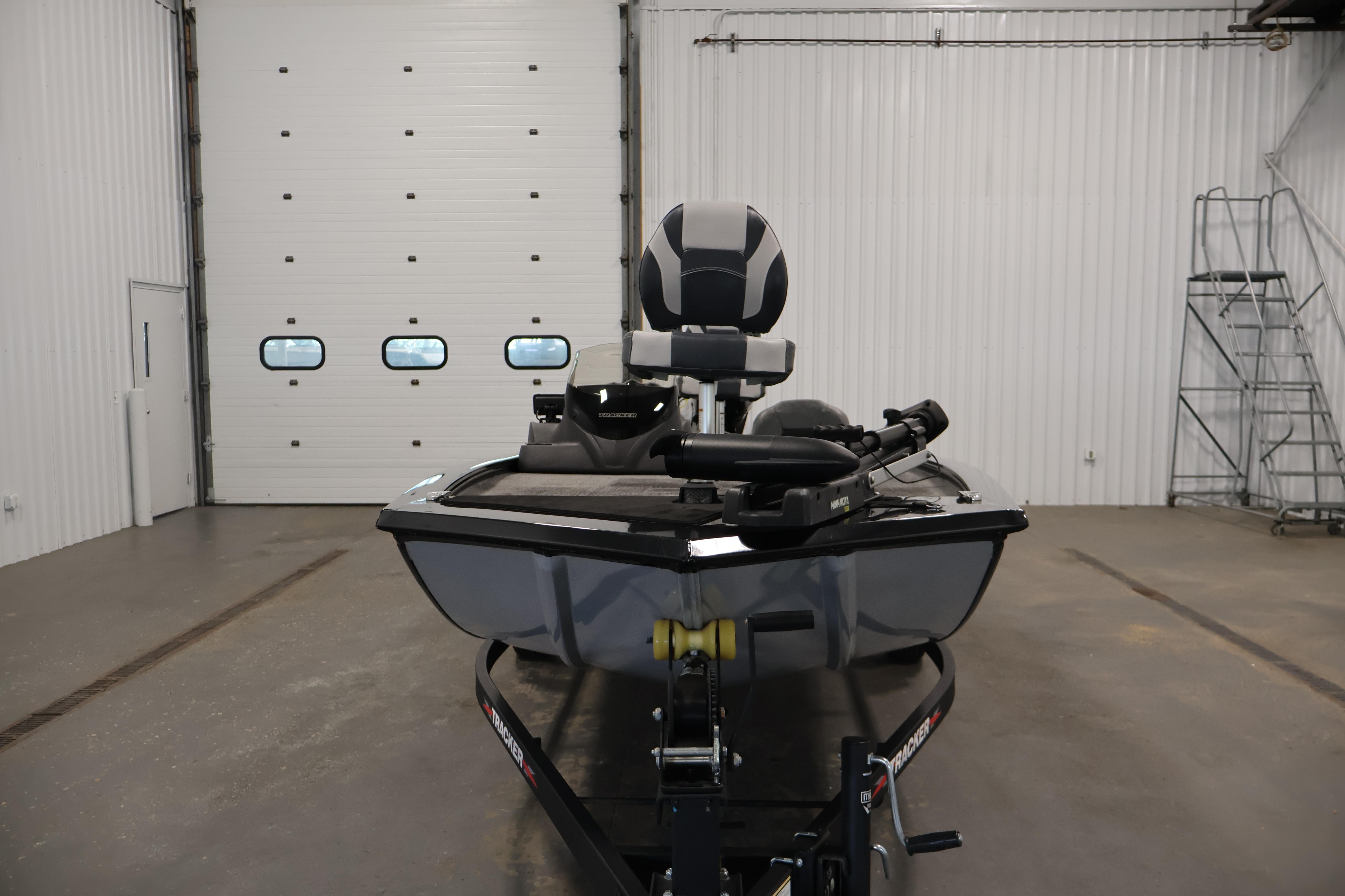 2024 Tracker Pro 170 boat in a garage, showcasing front view and seating.