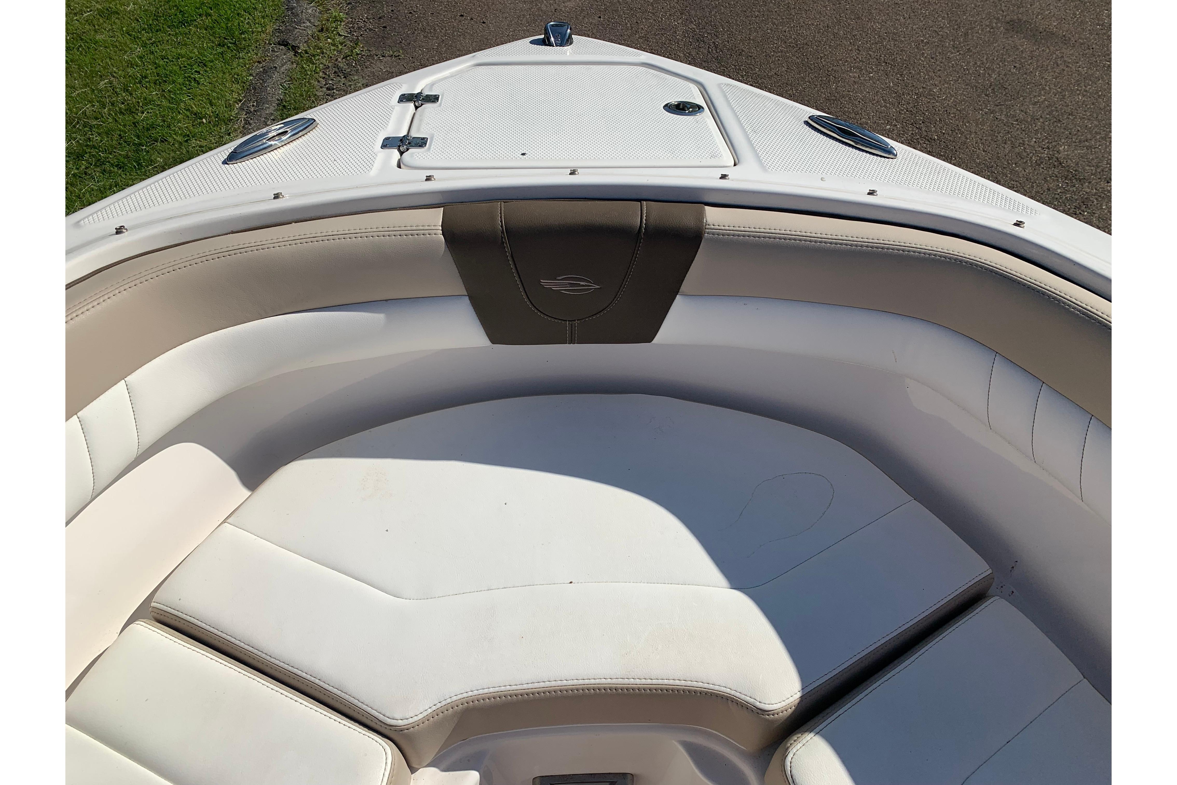 2022 Chaparral 23 SSi boat interior with white cushioned seating.