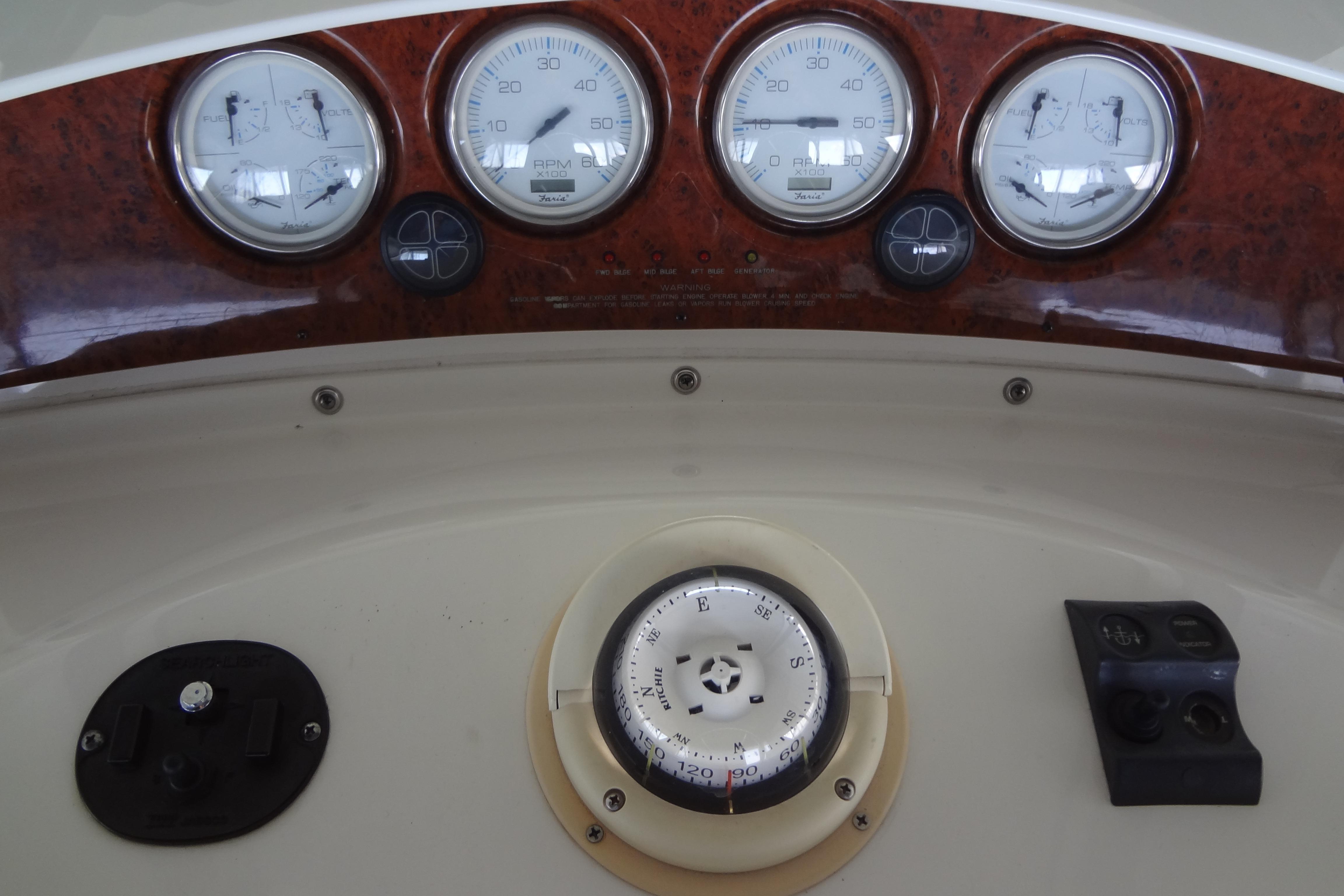 Dashboard of a 2005 Silverton 34 Convertible boat with gauges and compass.