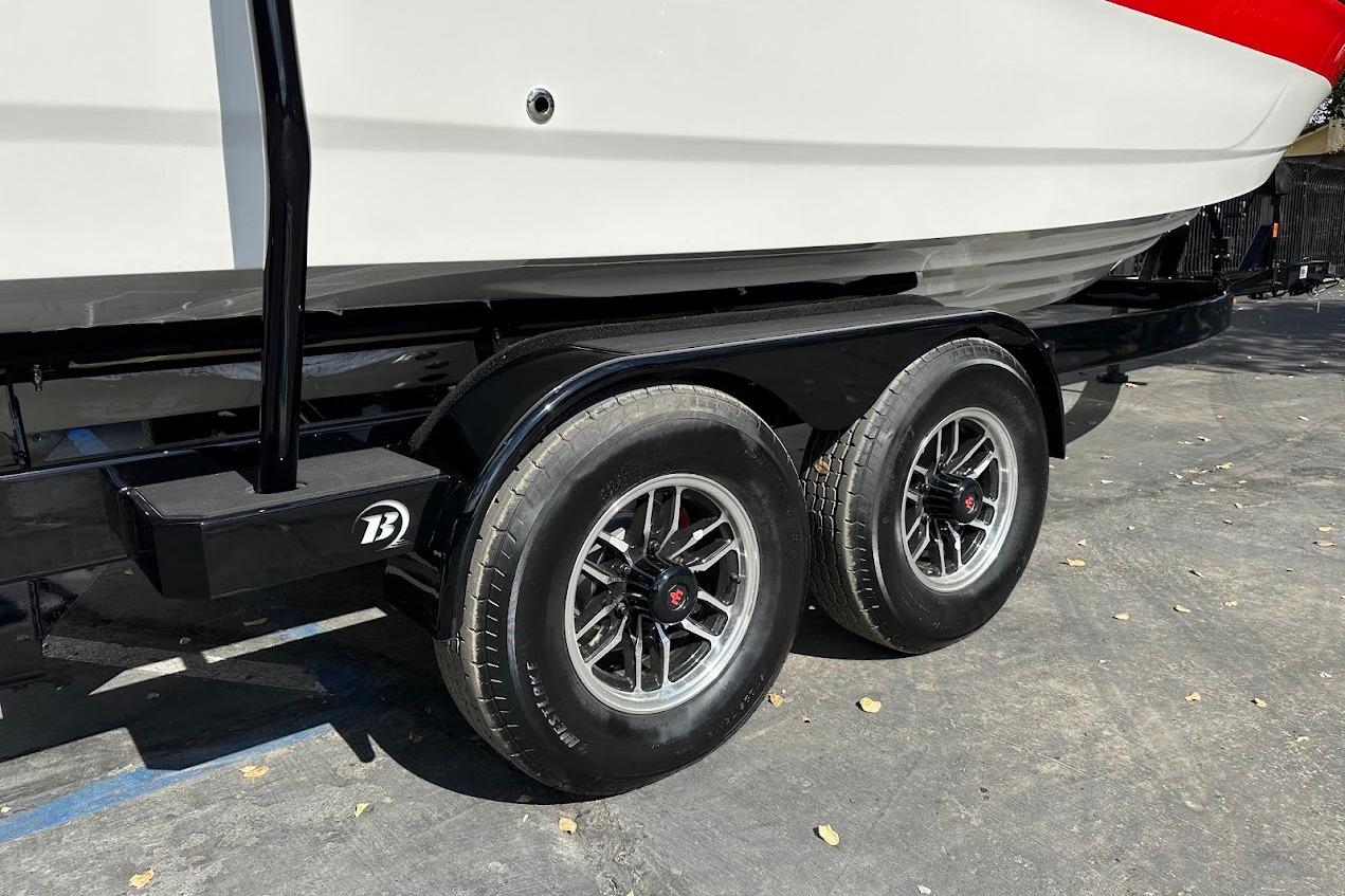 Trailer for 2026 Sea Ray SDX 230 Surf boat with dual wheels.