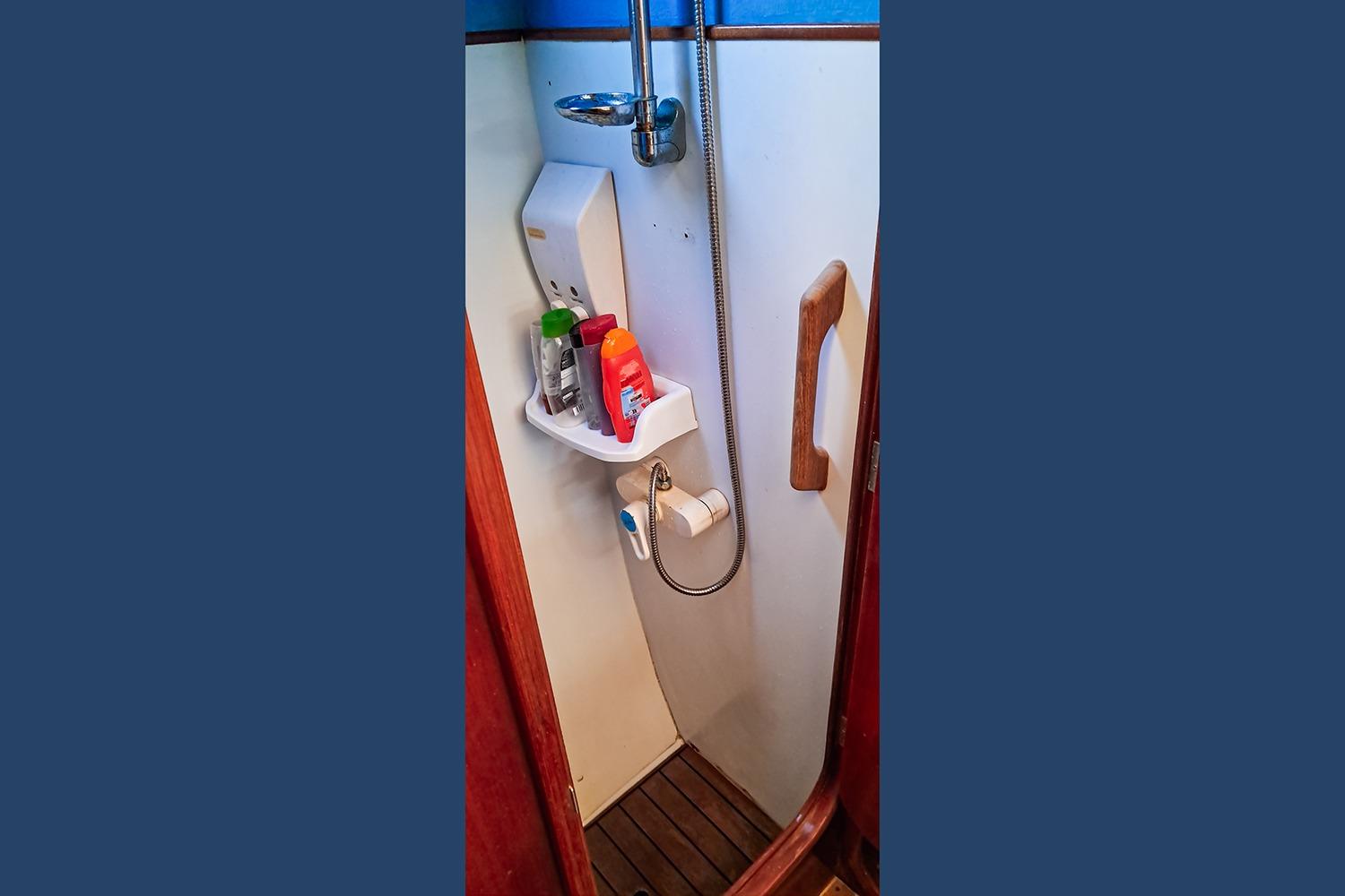 Compact bathroom with shower and toiletries on Privilege 39 yacht, 1992 model.