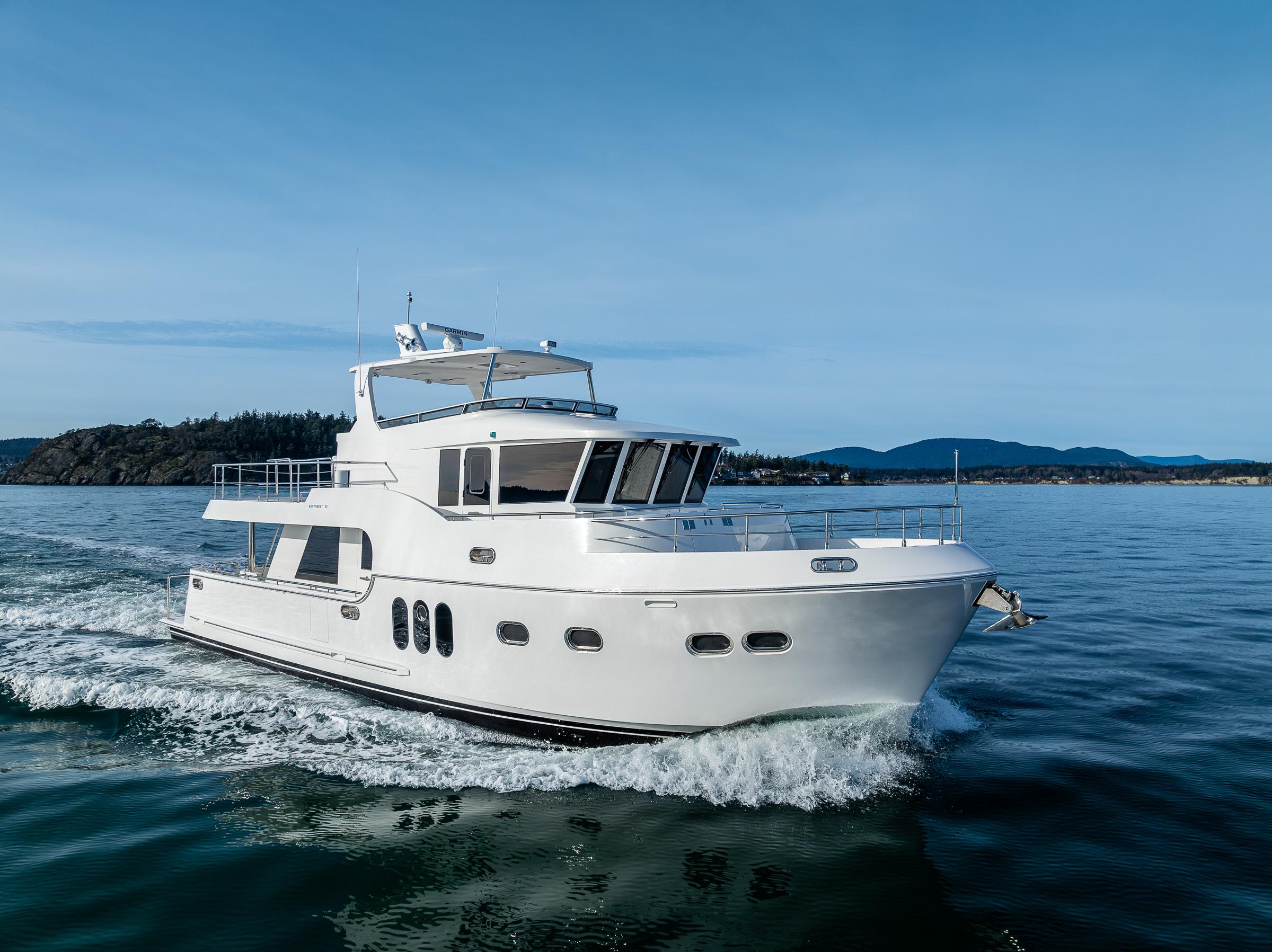 2024 Northwest 55 yacht cruising on open water, clear sky, scenic background.